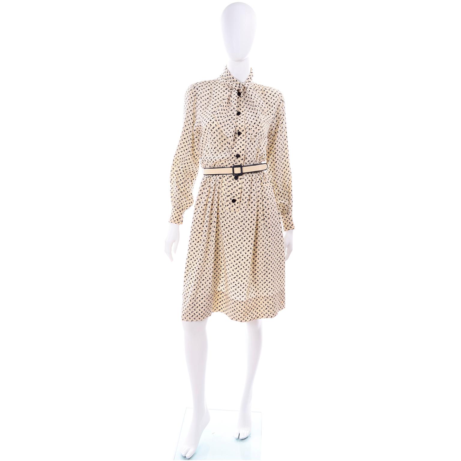 This is a lovely 1970's vintage Chanel silk dress is in a pretty black and light cream tulip floral print. This Chanel Créations long sleeve day dress has an attached scarf at the neckline that can be knotted or tied in a bow, and there are buttons