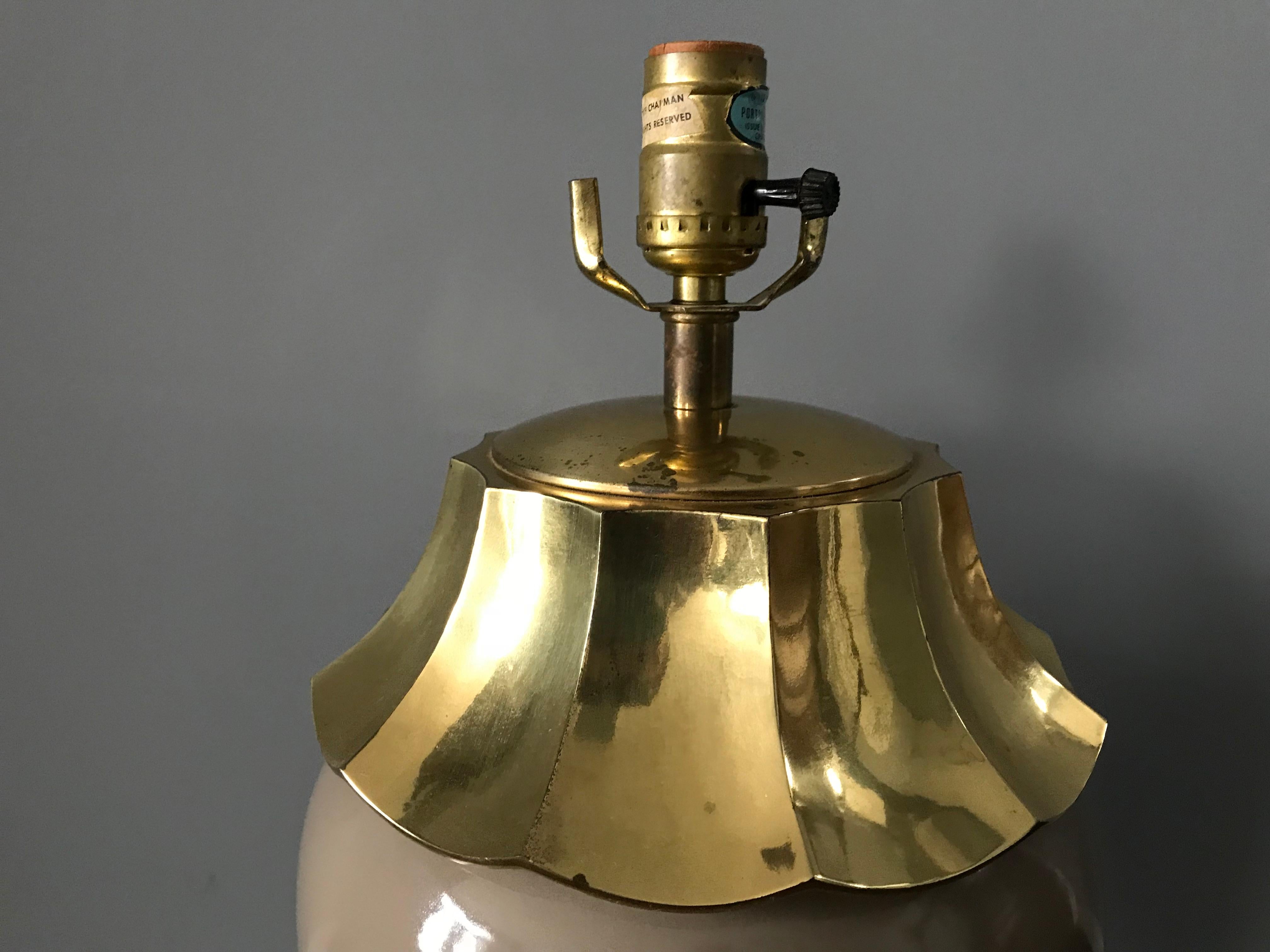 Offered is a fabulous, Chinoiserie meets Hollywood Regency, 1970's Chapman lamp. This gorgeous piece has a brass pagoda motif collar with a thick modern Ming-Style brass base. The center is a taupe tinted ceramic. Includes original 'Chapman' tag,