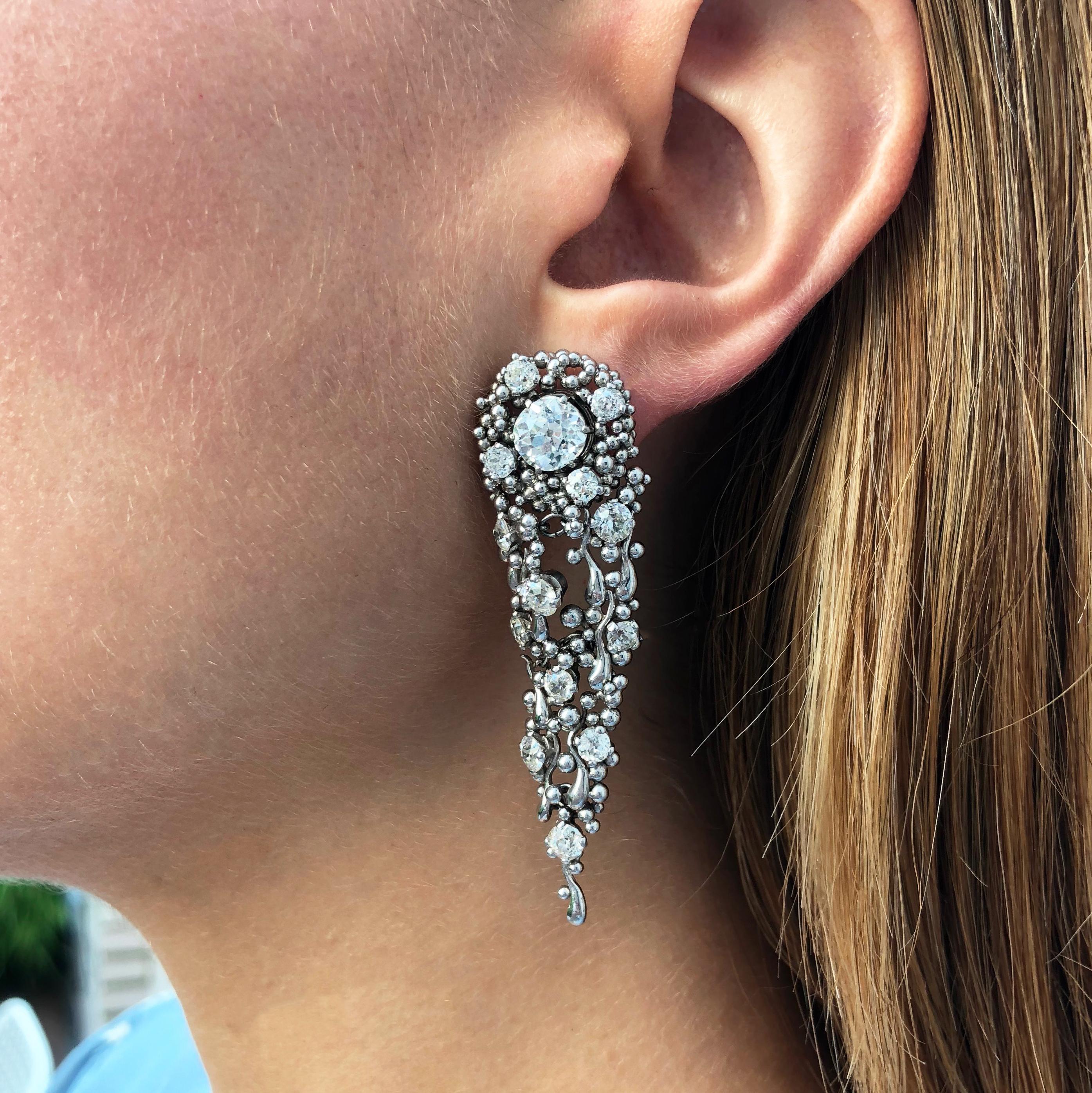 A highly collectible  pair of diamond and platinum convertible day/night ear pendants, by British sculptor and jewelry designer, Charles de Temple, c. 1975. The earrings are stamped CdeT and measure 2.25