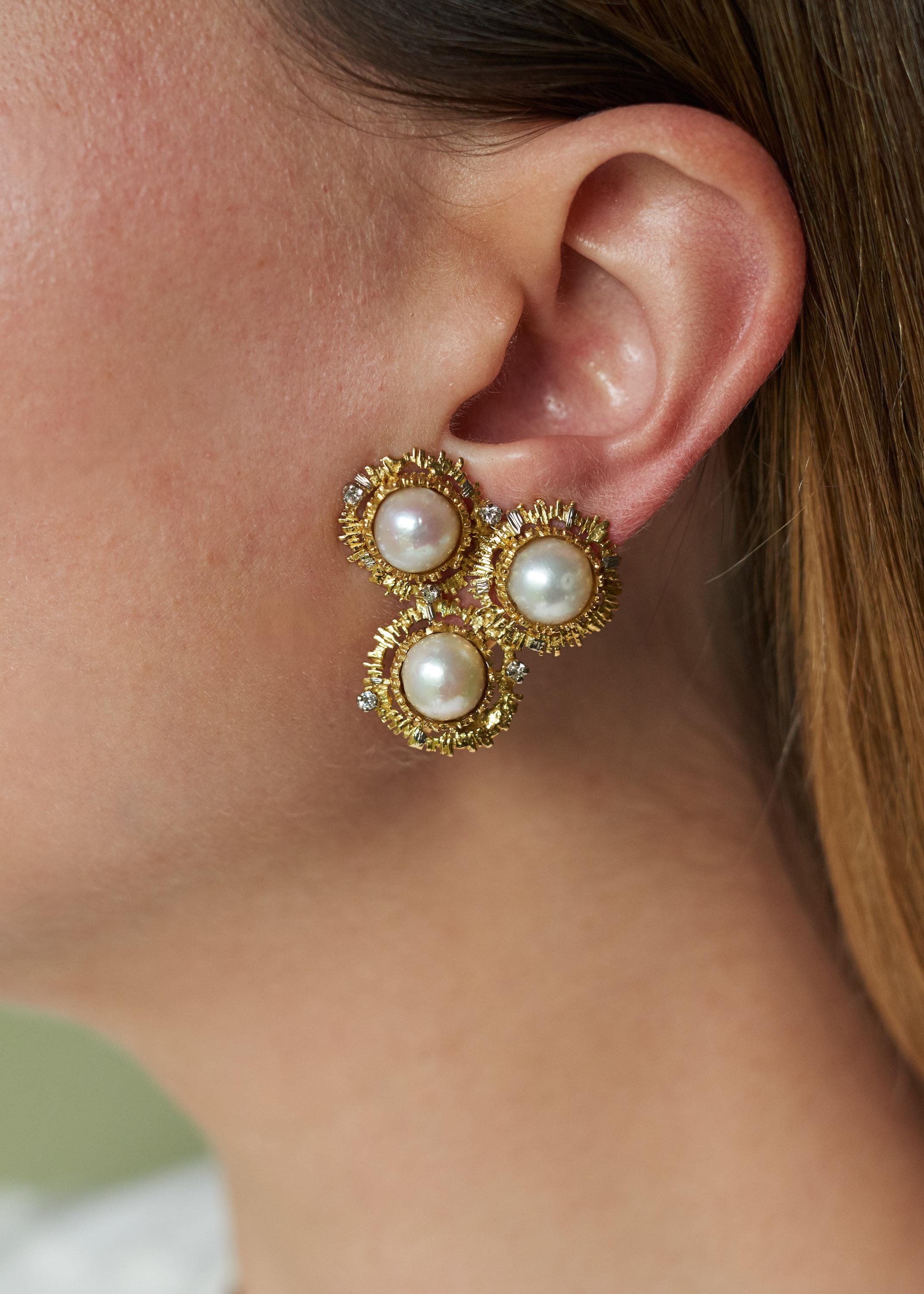 A pair of mabe pearl, diamond and 18 karat gold ear clips, by British jewelry designer Charles de Temple, c. 1975.

Five small diamonds are set in each ear clip. Unsigned but the earrings are featured in the Charles de Temple Catalog. 

Omega clip