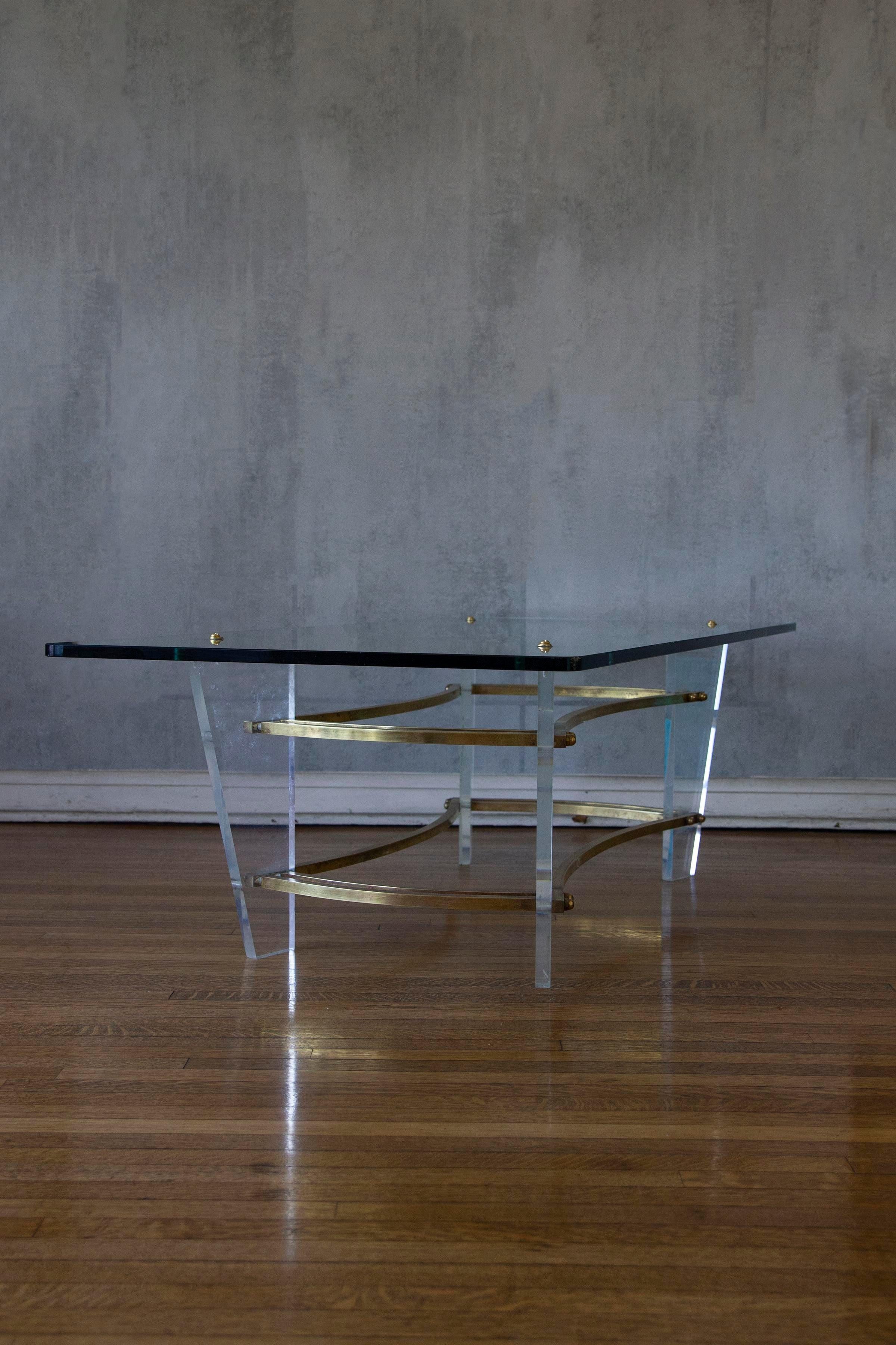Mid-Century Charles Hollis Jones elegant vintage modern coffee table features a brass and Lucite base with a glass top. Stylish Minimalist design Brass and Lucite is sure to complement any home keeping your space airy and open.