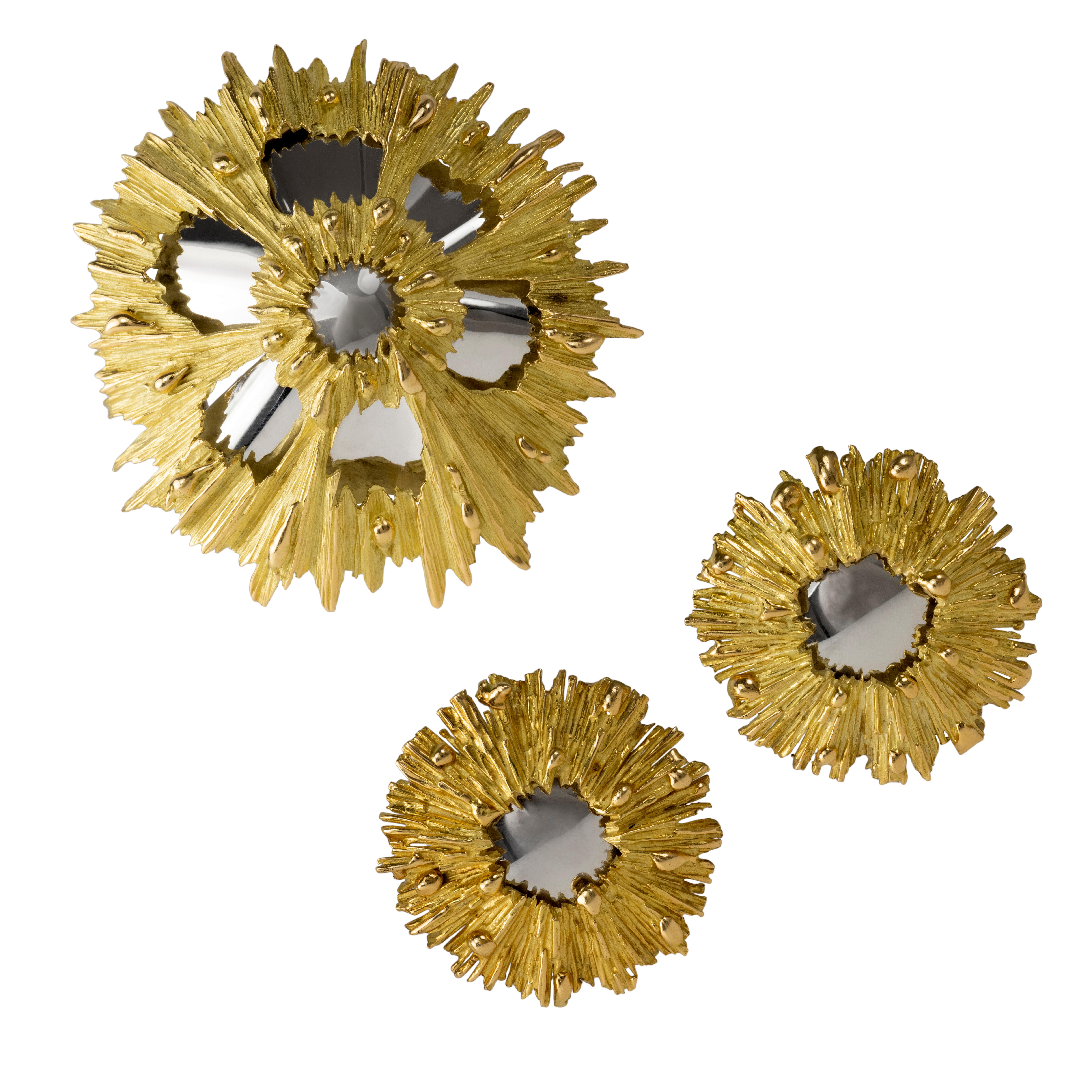 A mirror finish 18 karat white gold and textured 18 karat yellow gold brooch and ear clips set, by Chaumet, 1970s. 

The earrings measure 1.3