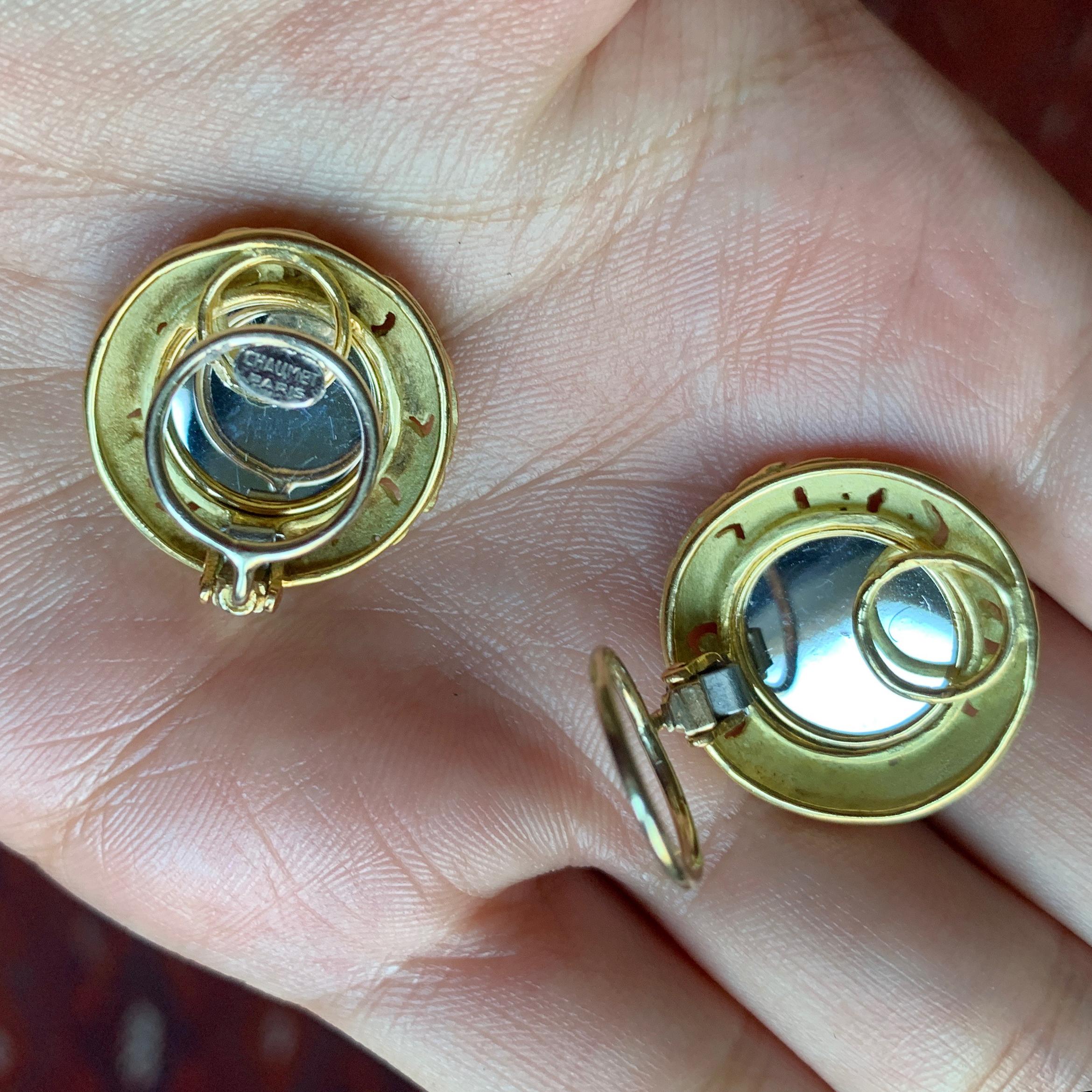 A pair of 18 karat mirror polished white gold and textured yellow gold ear clips, by Chaumet, c. 1970. 
The earrings are stamped Chaumet Paris and have French stamps.