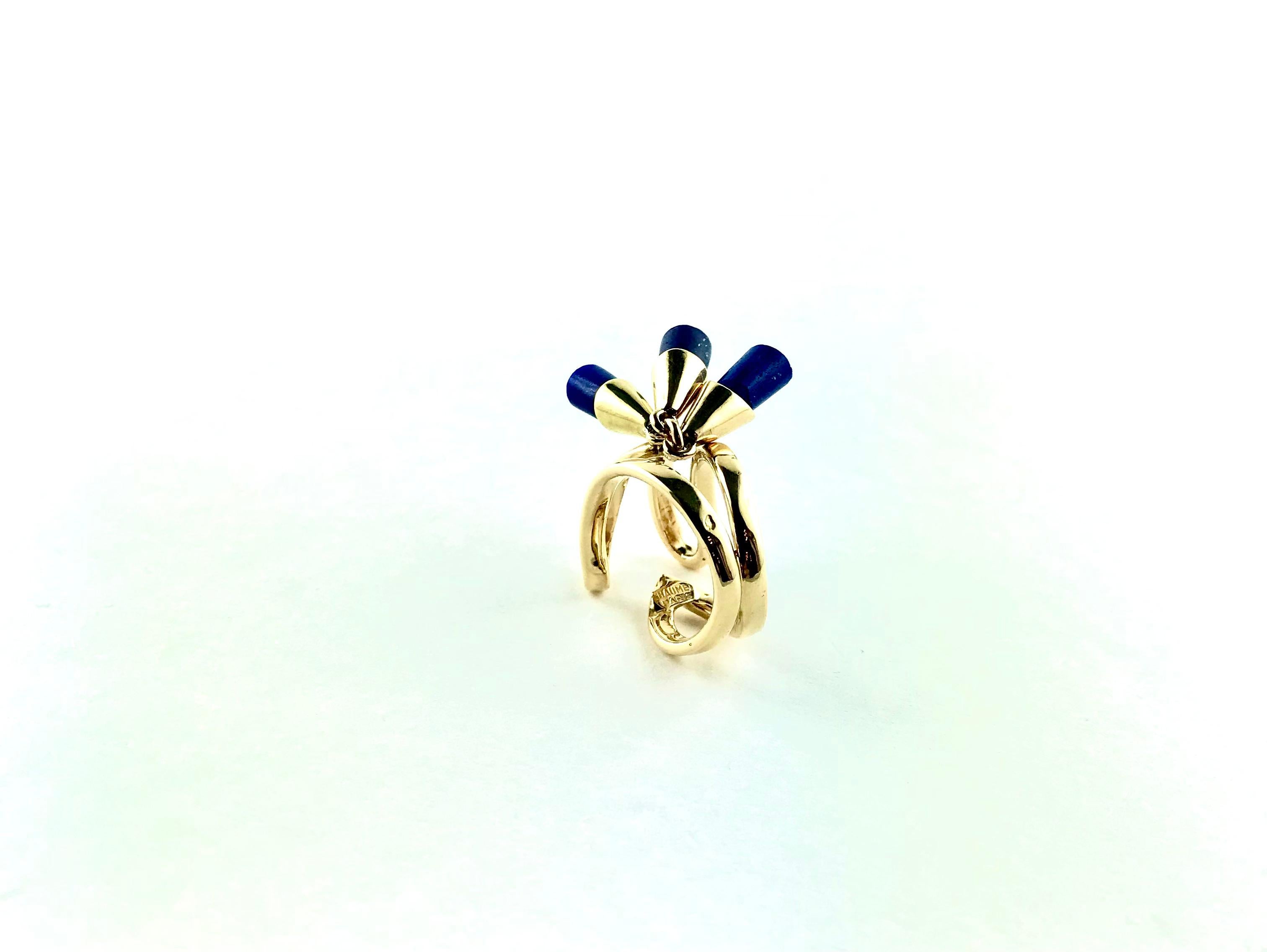 Sleek and  classy multi-charm 1970s Ring, designed by french jeweler Chaumet and crafted in 18k polished finish Yellow Gold,  featuring three  separate dangling  Lapislazuli tassels dispersing laterally over the finger and securely attached to the