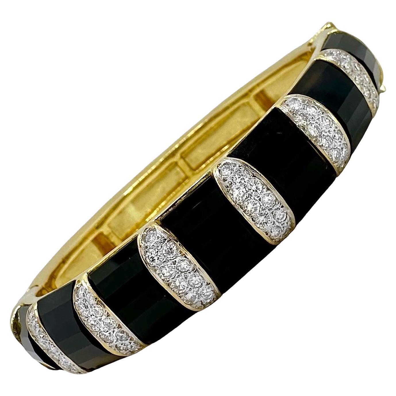 This beautiful and very well crafted 18k yellow gold bangle bracelet by well respected maker, La Triomphe is pure 1970's high style. Characteristic of their offerings, every element of this hinged bracelet is artfully done. Every diamond is set into