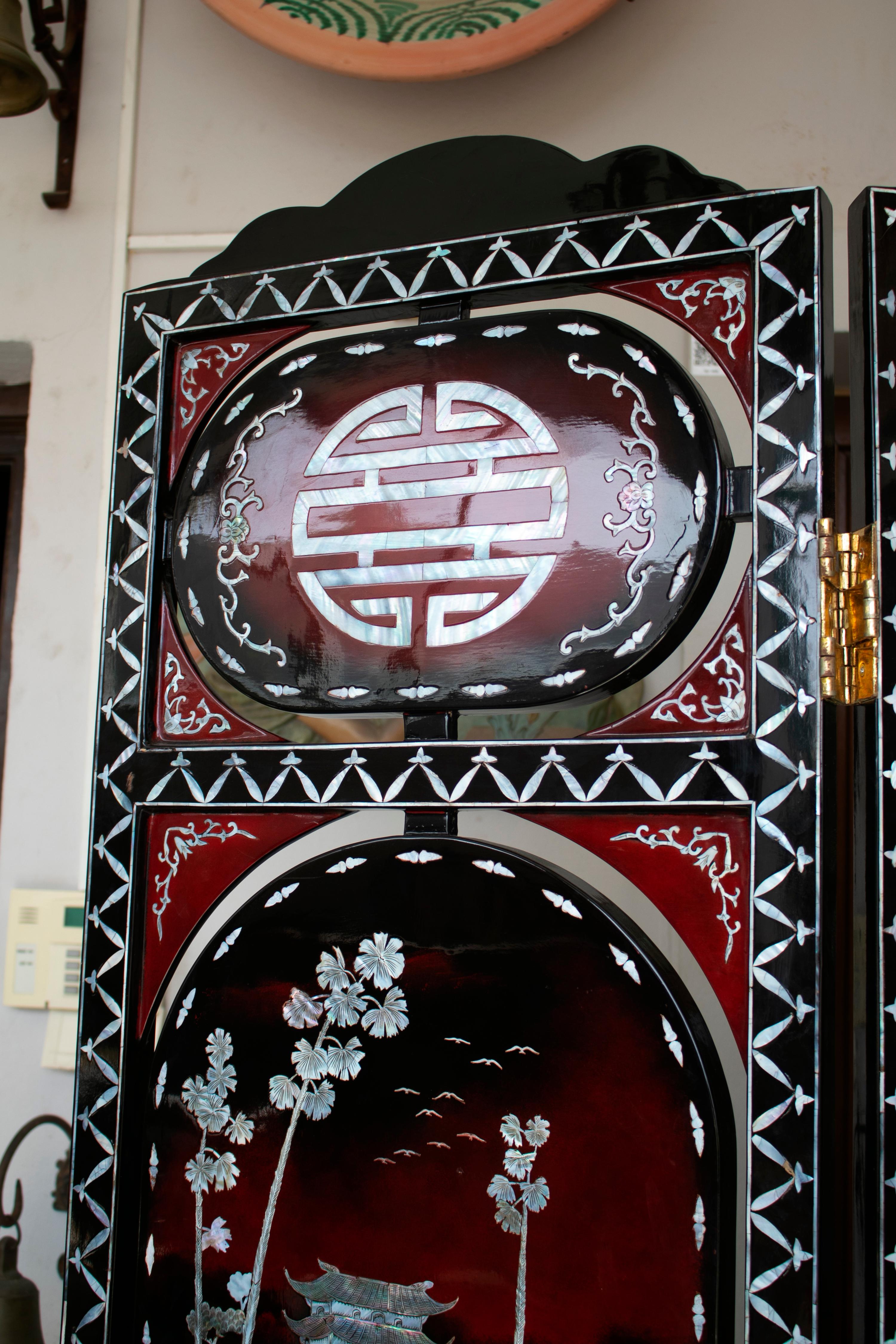 1970s Chinese lacquered folding screen with mother of pearl inlay Asian motifs. 

 