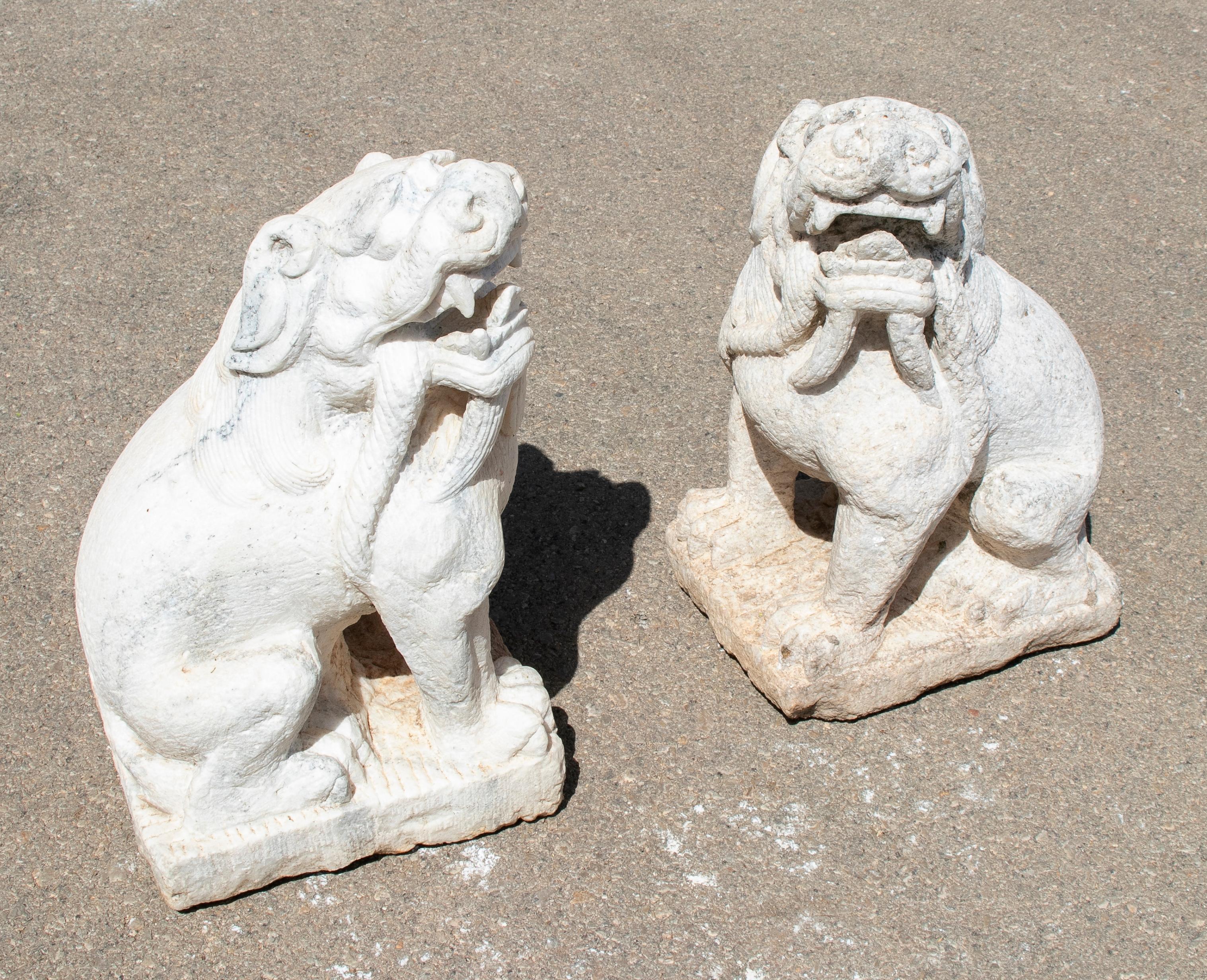 1970s Chinese pair of hand carved white marble lions.