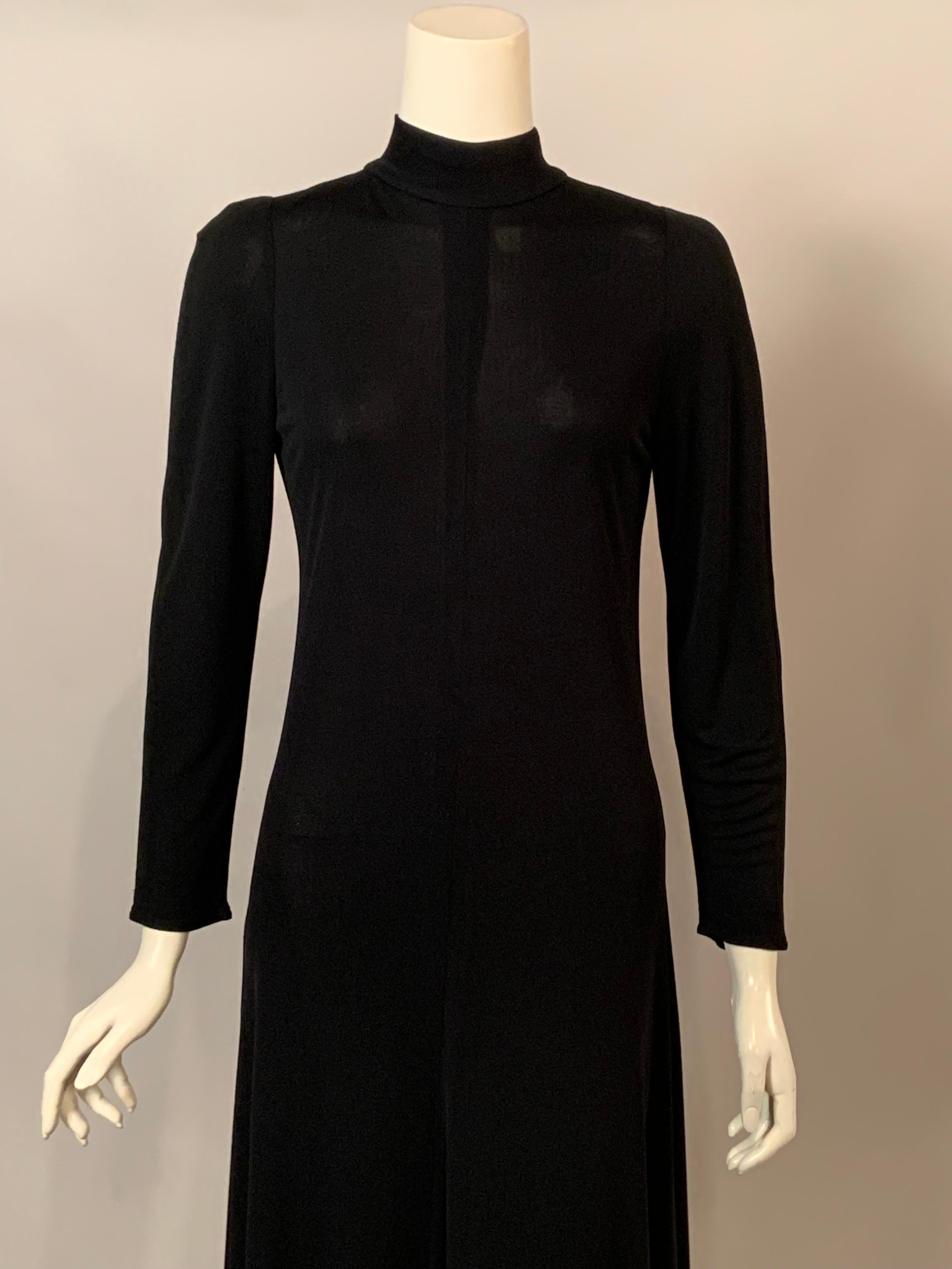 Karl Lagerfeld designed this classic little black dress for Chloe in the 1970's. The dress has a high neckline with three buttons and loops at the center back above the center back zipper.  It is in excellent condition and is marked a vintage size