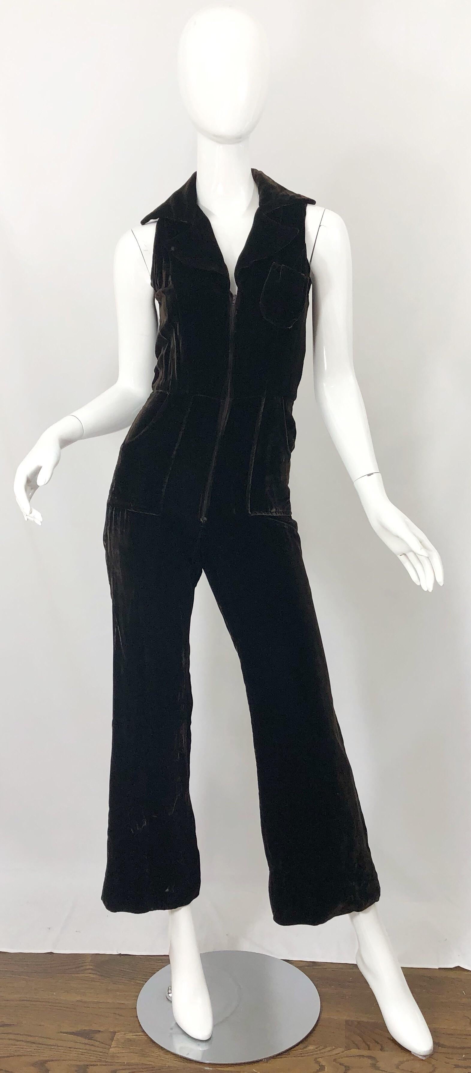 Awesome vintage 70s chocolate brown velvet bell bottom one piece jumpsuit! Features a fitted tailored collared bodice and trousers that leads to wide flared legs. Pocket at left breast and at the side of each hip. Hidden zipper up the front. Super