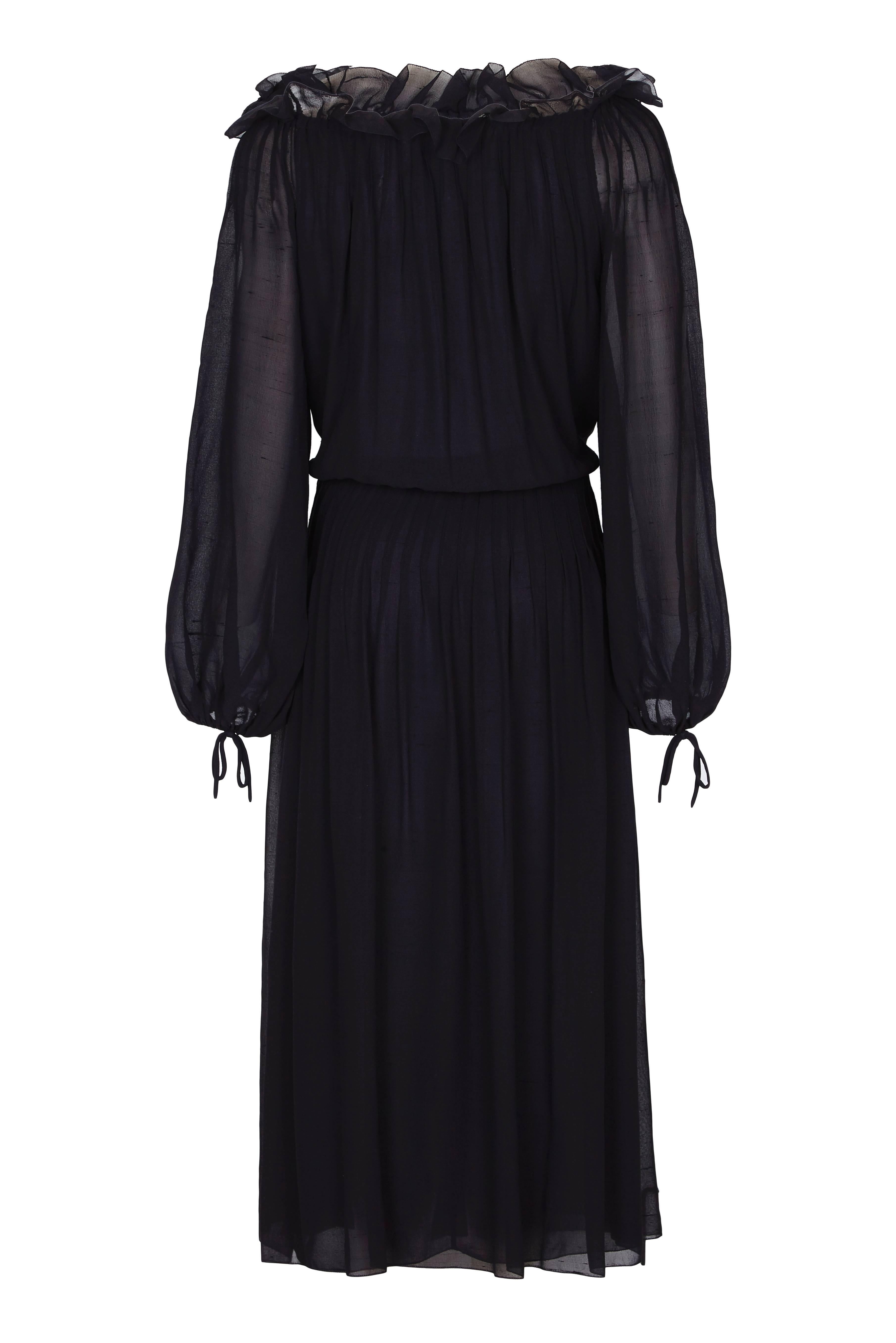 Vintage 1970s Christian Dior black silk chiffon dress with balloon sleeves and ruffled neckline.  The skirt and bodice of the dress have a double layer of chiffon while the sleeves are in a single layer making them more sheer. There are tie details