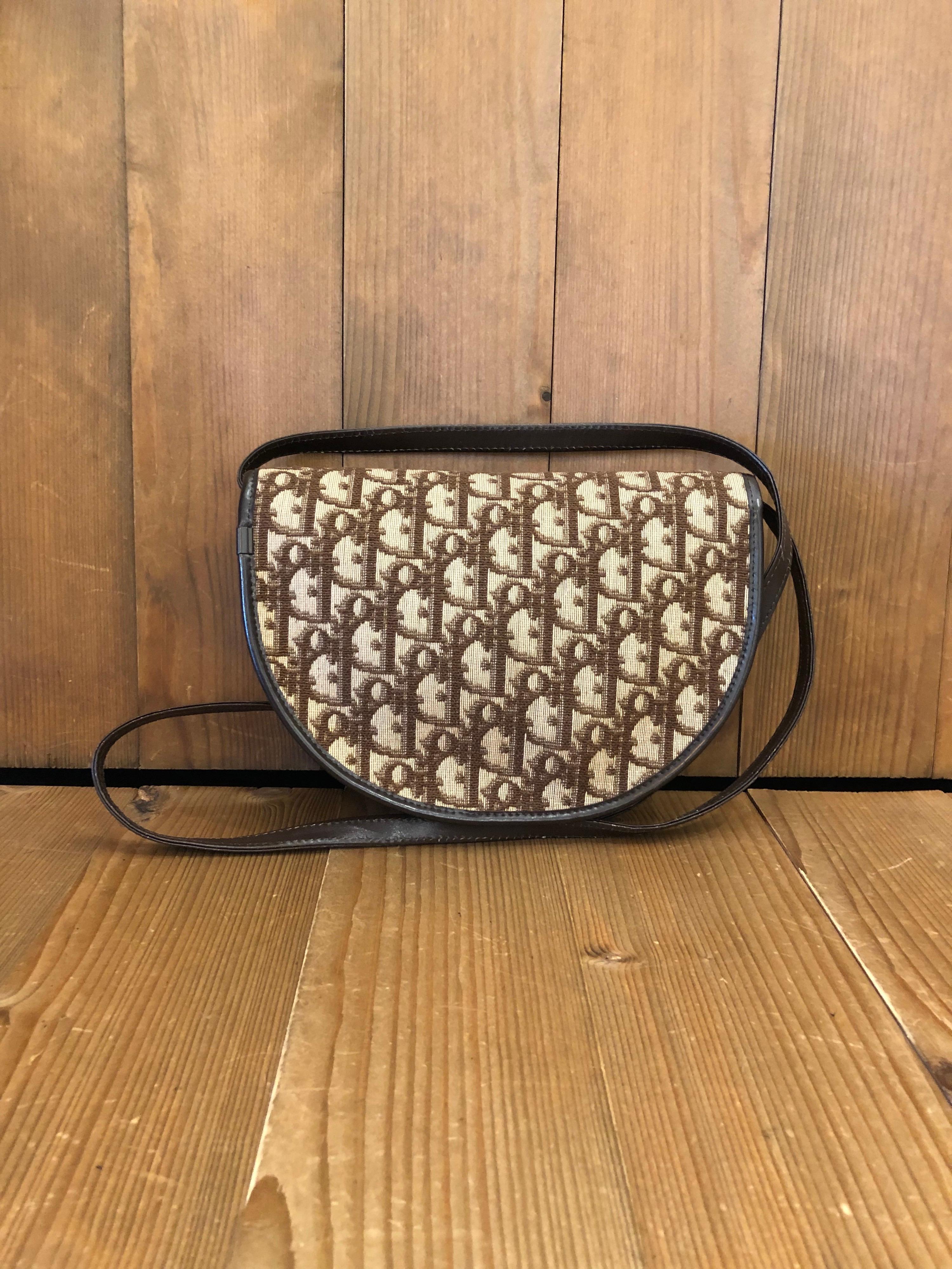 1970s Christian Dior shoulder bag in brown trotter jacquard and leather. Made in France. 
Measures 8.5 x 6.5 x 1 inches Strap drop 21 inches .

Condition - Some signs or wear consistent with age

Outside: Some old keeping marks on jacquard and