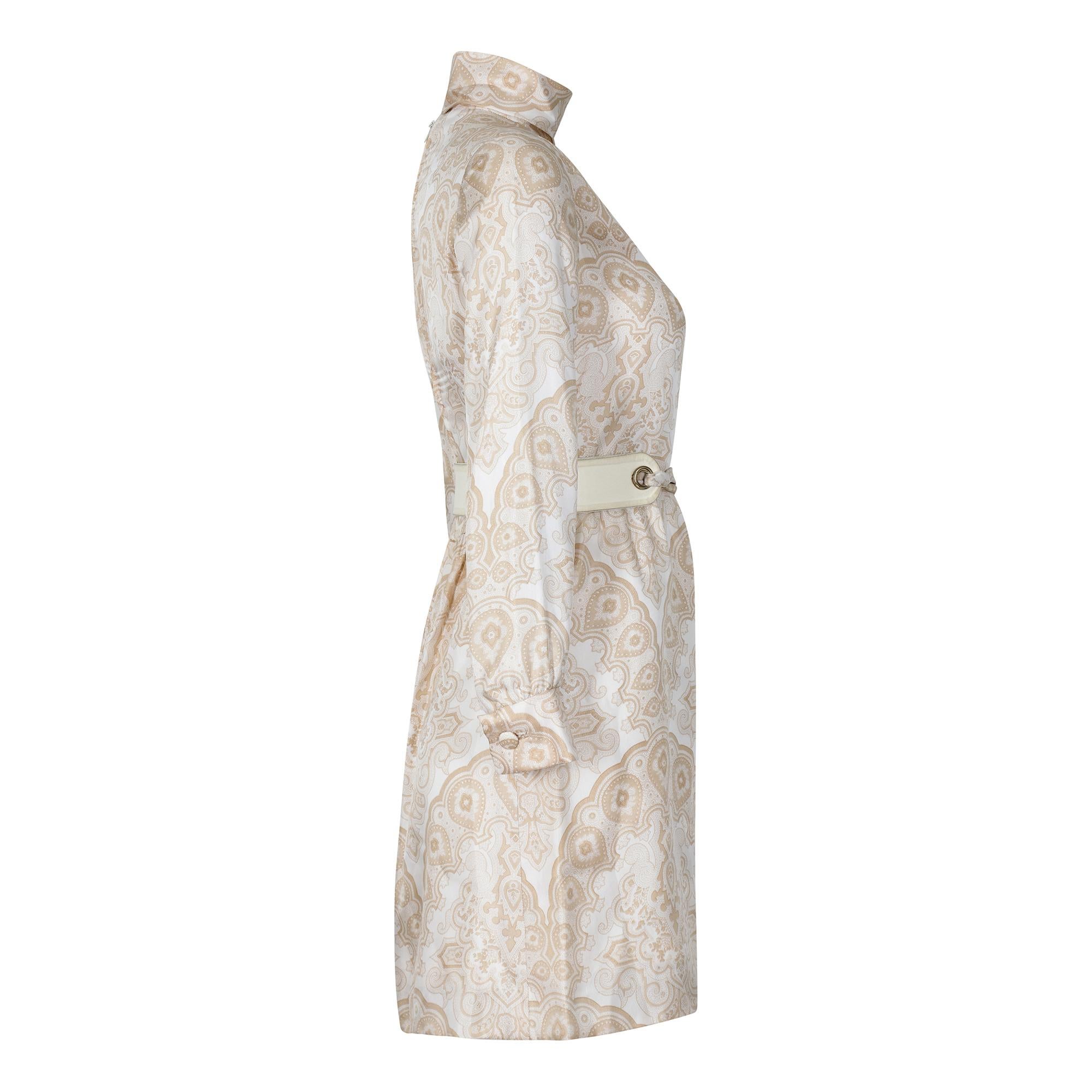 This 1970s silk dress by Christian Dior is classic French chic at its best. It features a high collar, long shirt sleeves with fabric covered buttons on the cuffs and a straight cut skirt that finishes at the top of the knee. The print has an exotic
