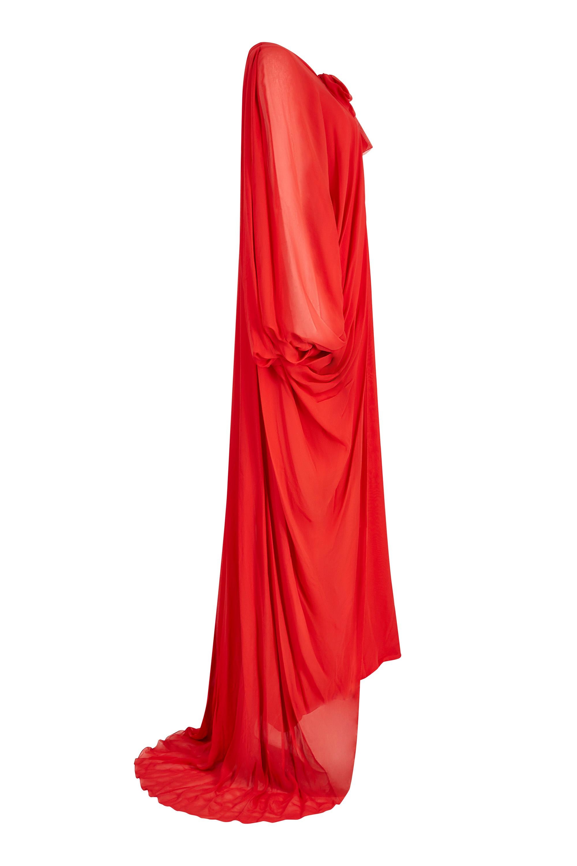 This sensational demi couture 1970s red silk chiffon evening gown is by iconic brand Christian Dior when celebrated designer Marc Bohan was at the helm. This show stopping piece is comprised of a silk lined chiffon slip and floor length chiffon