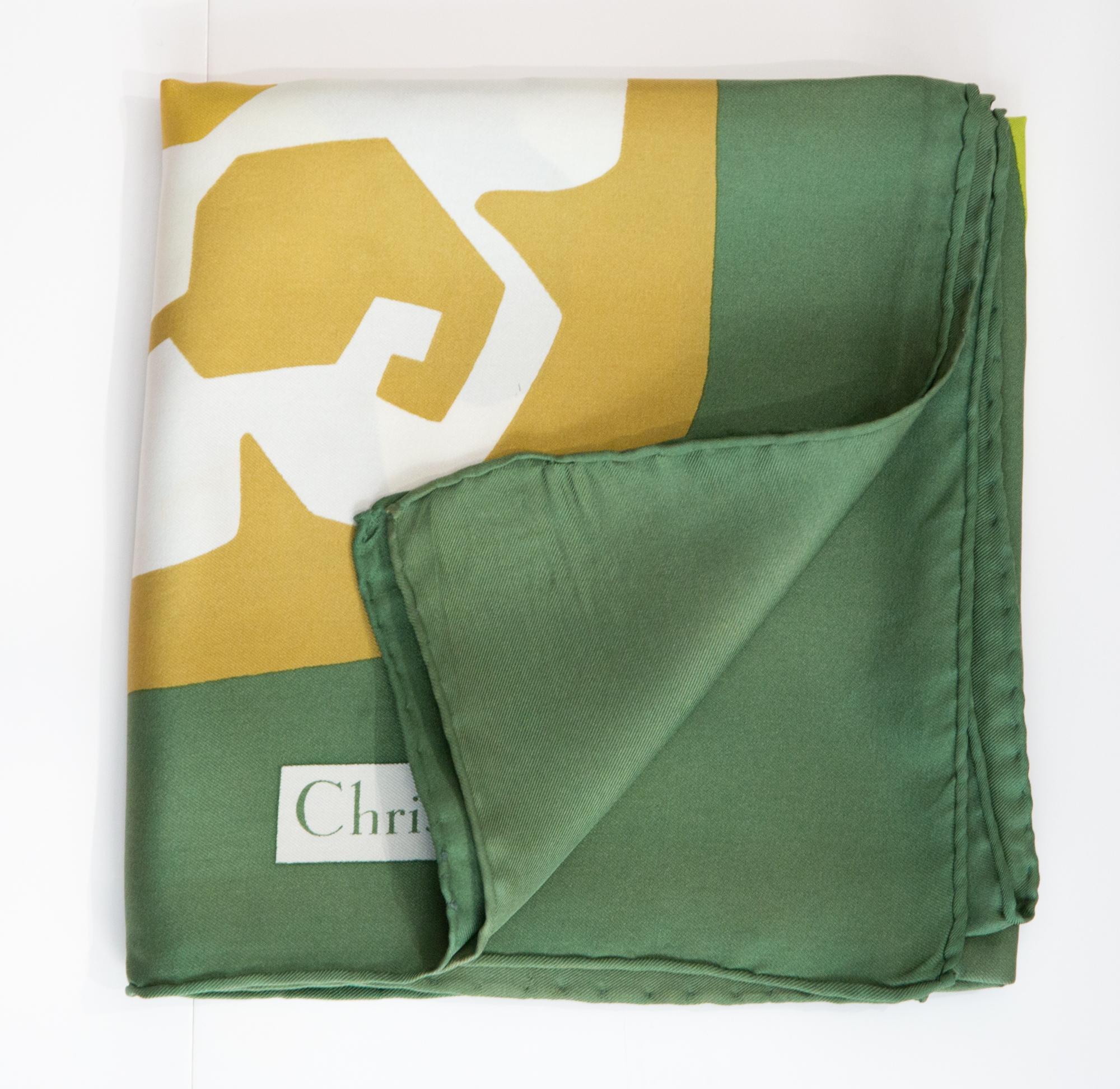 Christian Dior green Silk Scarf featuring a 70s flower pattern, a green border, a Christian Dior signature. 
Circa 1970s
In good vintage condition. Made in France.
29.9in. (76cm) X 29.9in. (76cm)
We guarantee you will receive this  iconic item as