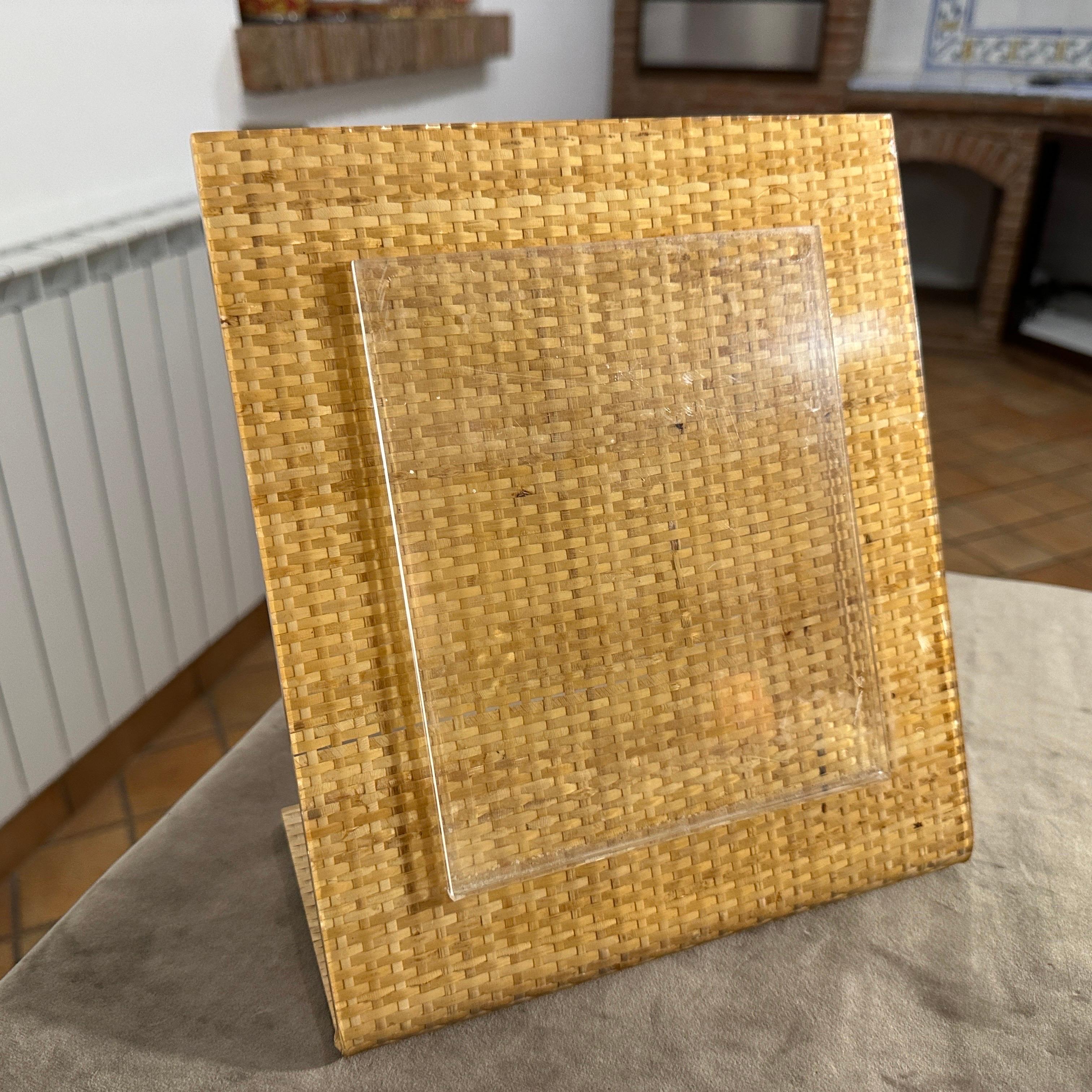 Questa cornice rettangolare Mid-Century Modern degli anni '70, progettata e prodotta in Italia nello stile di Dior Home, fonde perfettamente lusso ed elementi naturali. La struttura presenta una base in vimini finemente intrecciata, che emana una