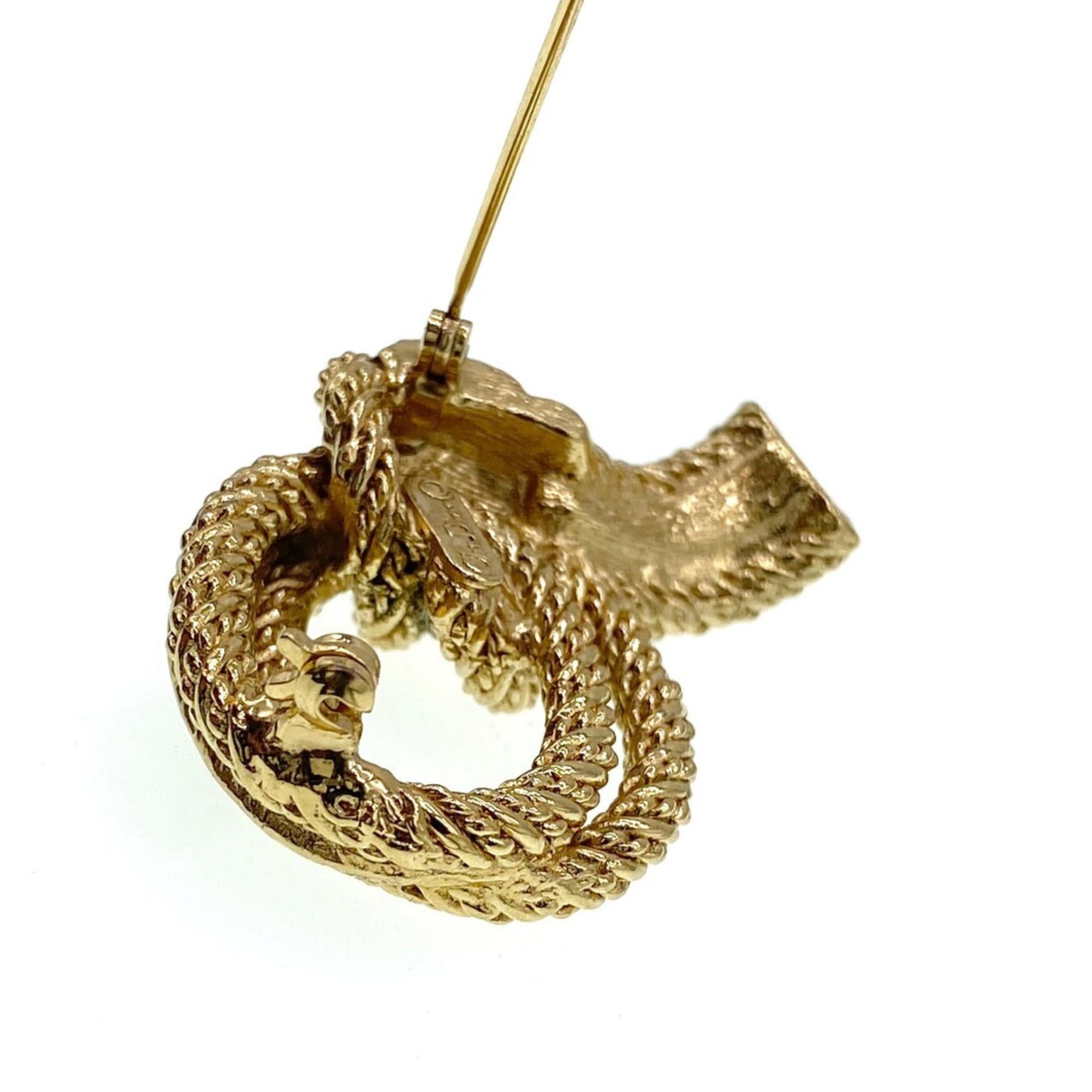1970s Christian Dior brooch almost certainly manufactured by Henkel & Grosse who have a long association with jewellery making for Dior. Crafted from a gold-toned alloy metal, it forms three strands of rope that form an elegant knot shape. Two of