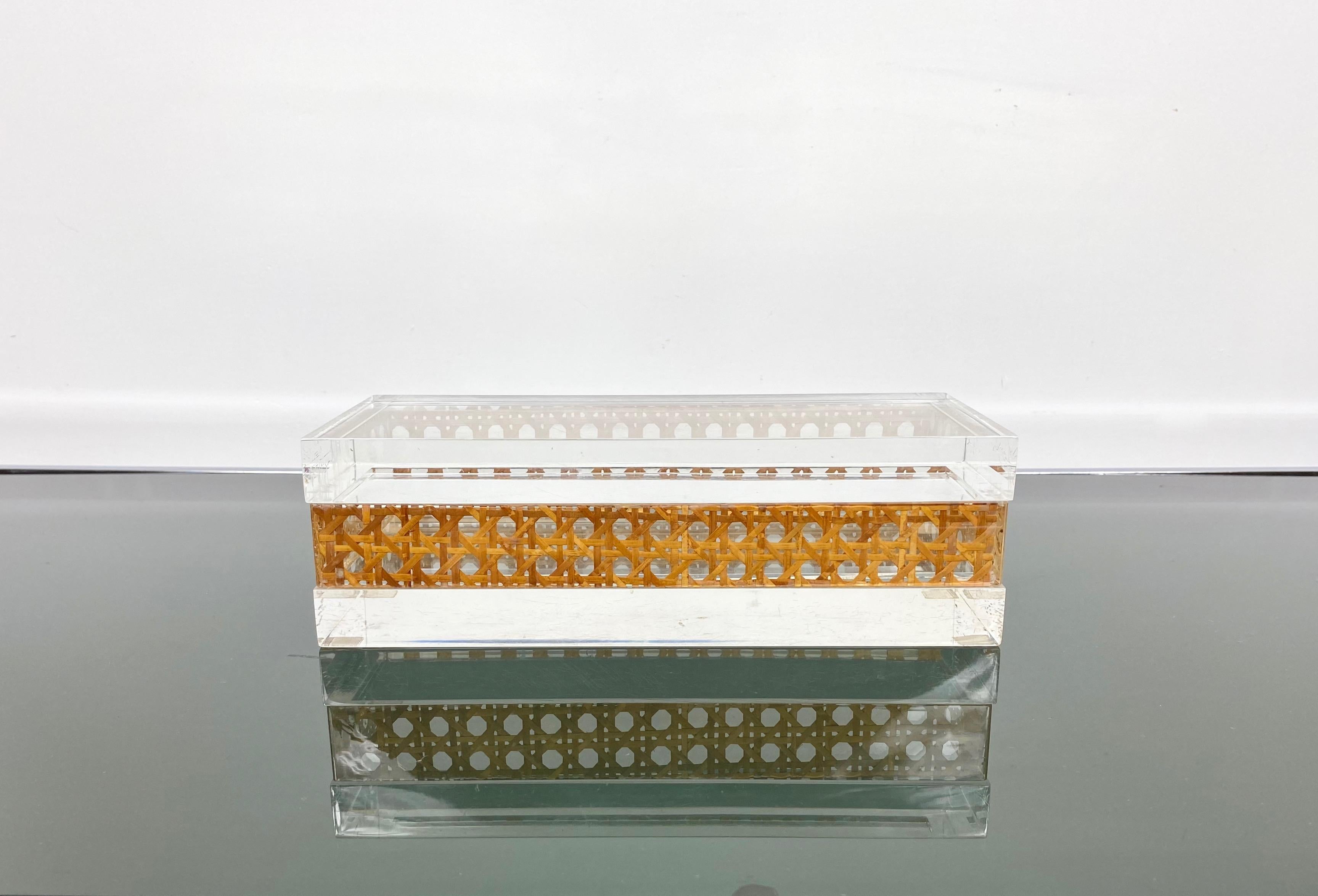 Stunning Mid-Century Modernist Lucite decorative box designed for Christian Dior Home Collection in 1970s. Large rectangular shape with real rattan canework embedded in the crystal clear Lucite. Great accessory for any modern interior.