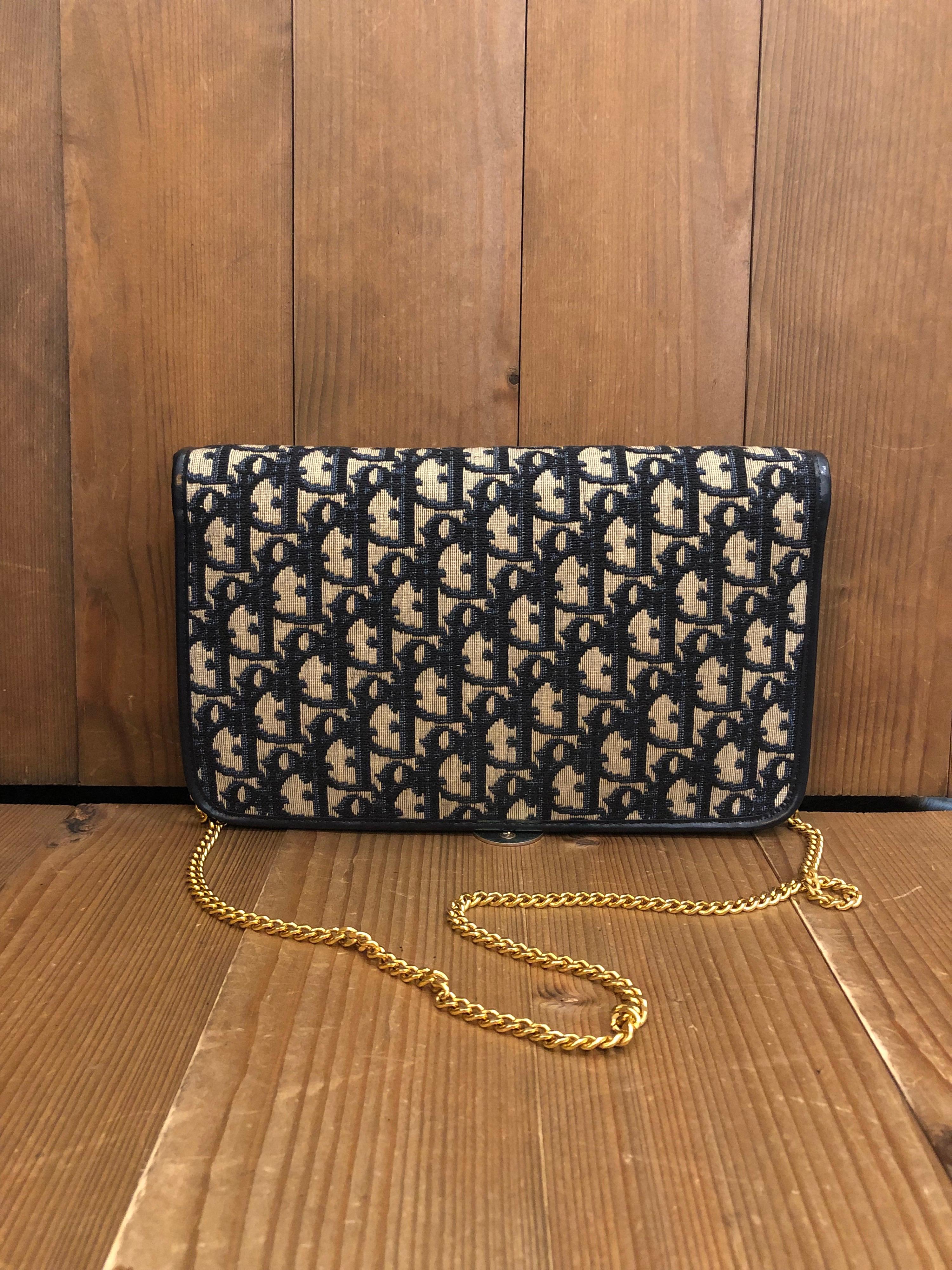 Vintage CHRISTIAN DIOR Chain Shoulder Bag in Dior's iconic trotter jacquard in navy featuring two main flat pockets and one small pocket in the middle. Made in France. Measures 10 x 6 x 1 inches Chain drop 16.5 inches at its longest. It can be worn