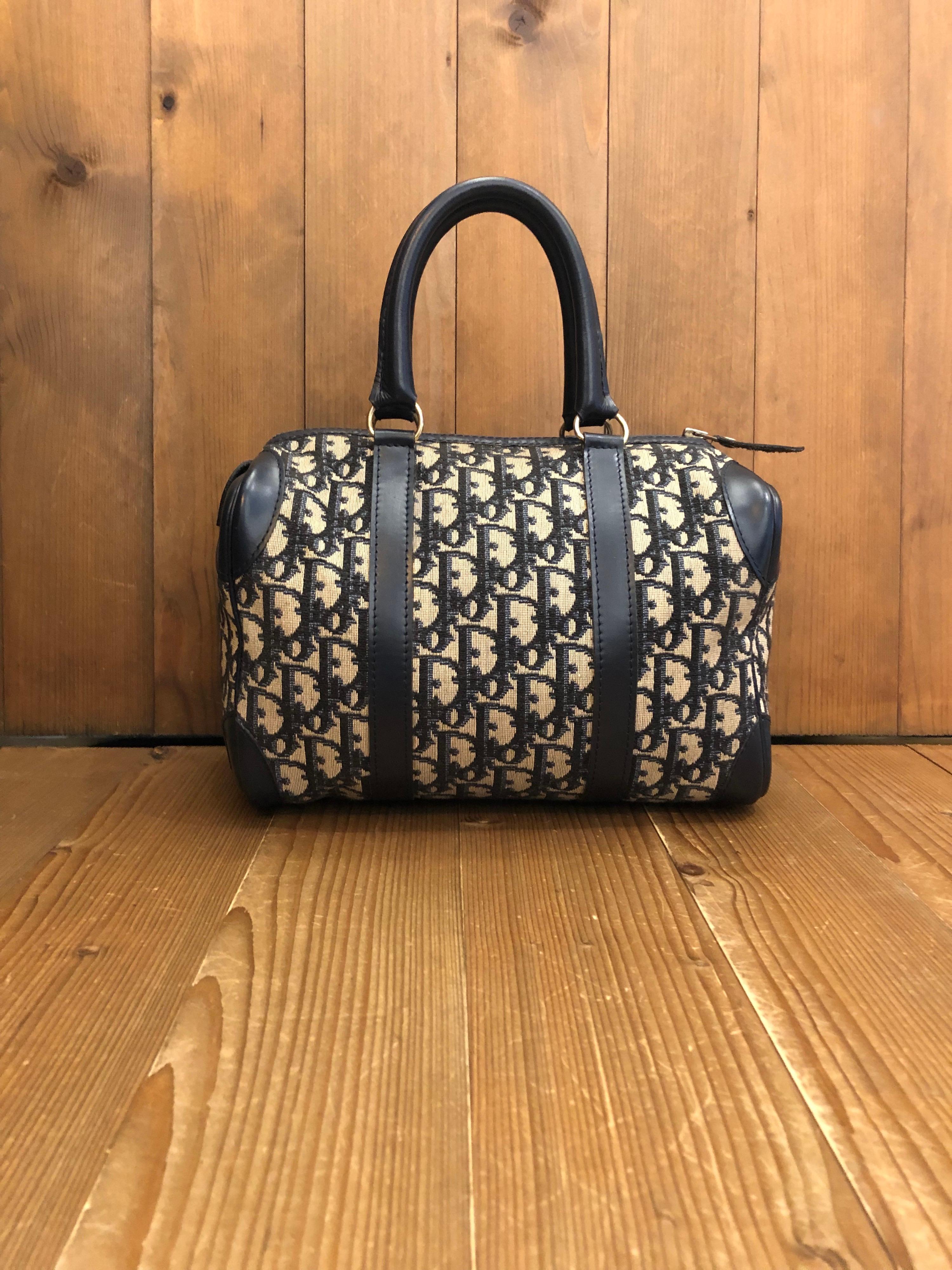 1970s CHRISTIAN DIOR small boston bag in navy trotter jacquard with leather trimmings. Made in France. Measures 10 x 7 x 5.5 inches handle drop 5 inches.

Condition - Minor signs of wear. Generally in very good condition. A very well maintained Dior