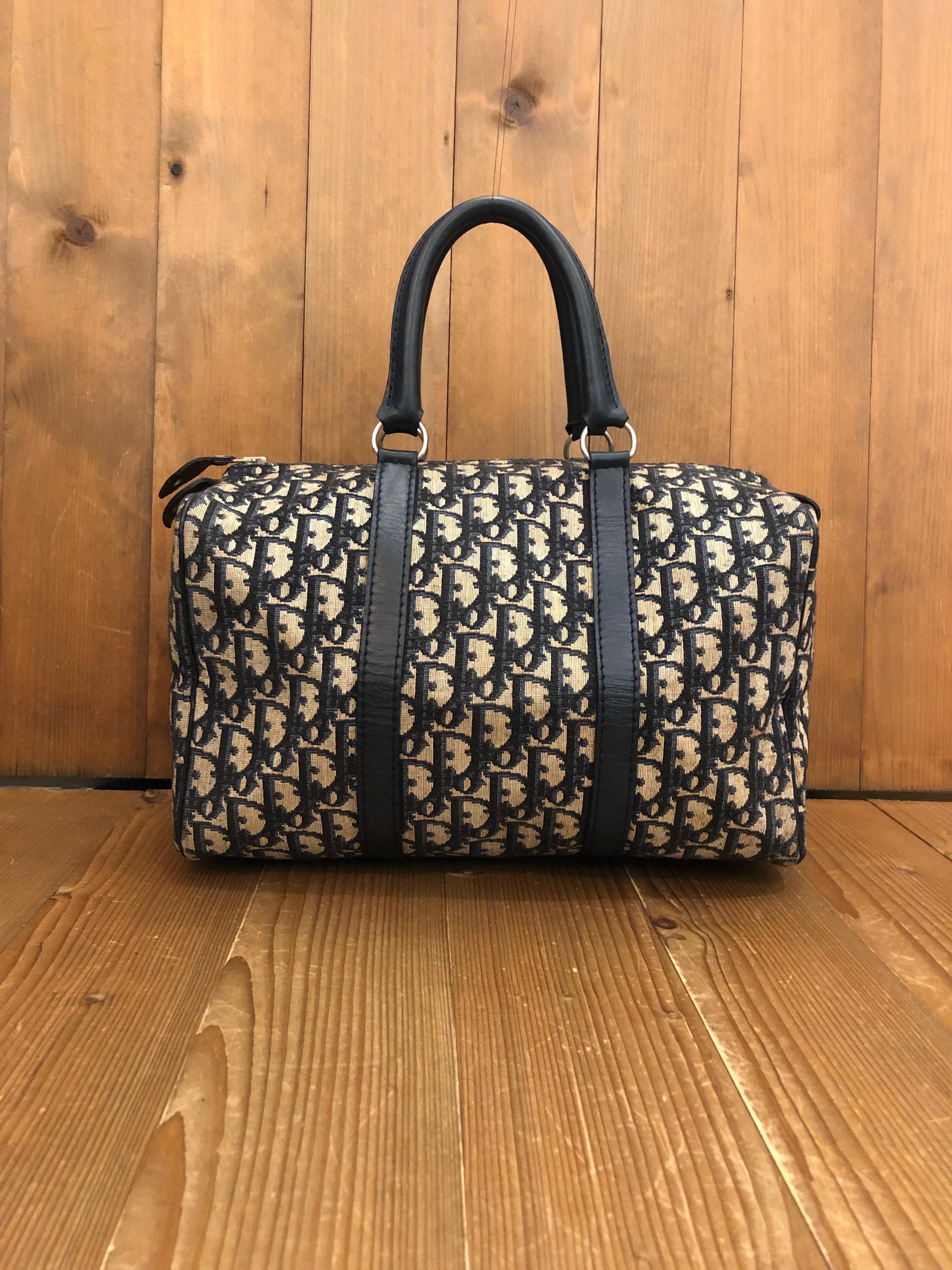 1970s CHRISTIAN DIOR Trotter Boston Bag 30 in navy jacquard. 
Material: Jacquard and leather
Color: Navy
Origin: France 
Measurements: 12”x7.5”x6.5”
Handle Drop. 5”
Specifications: 1 interior zip pocket 

Condition:
Outside: Some marks on jacquard
