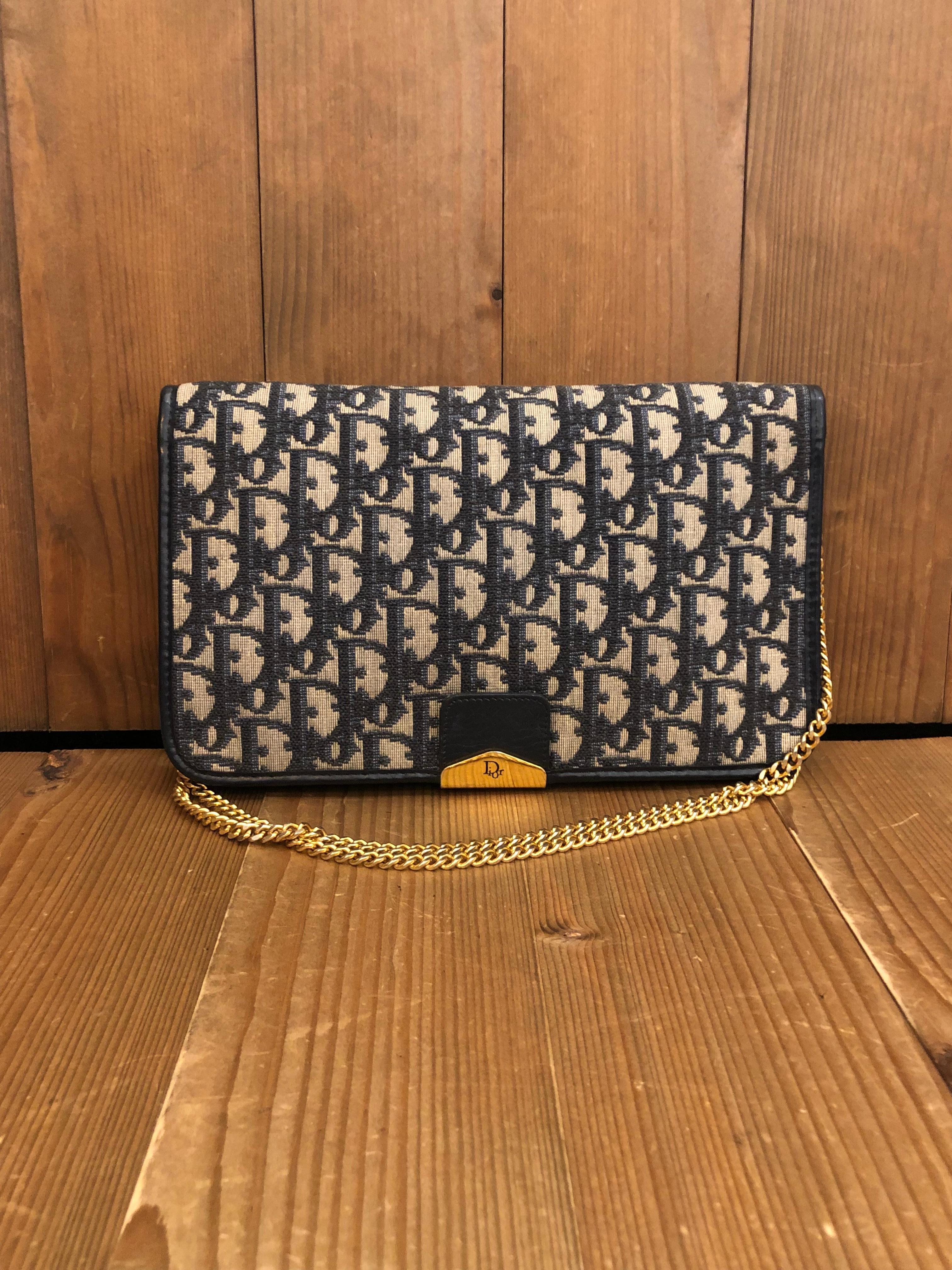 1970s CHRISTIAN DIOR Chain Shoulder Bag in Dior's iconic navy trotter jacquard features two main flat pockets and one small pocket in the middle. Made in France. Measures 10 x 6 x 1 inches Chain drop 16.5 inches at its longest. It can be worn