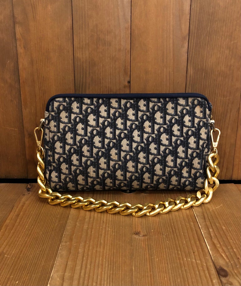 1970s CHRISTIAN DIOR Navy Trotter Jacquard Clutch Bag with leather interior. Made in France. Measures 10.25 x 6.5 x 1.5 inches. Third party non-Dior parts are added on each side to secure a jumbo gold toned chain. 

Condition: Some signs of wear