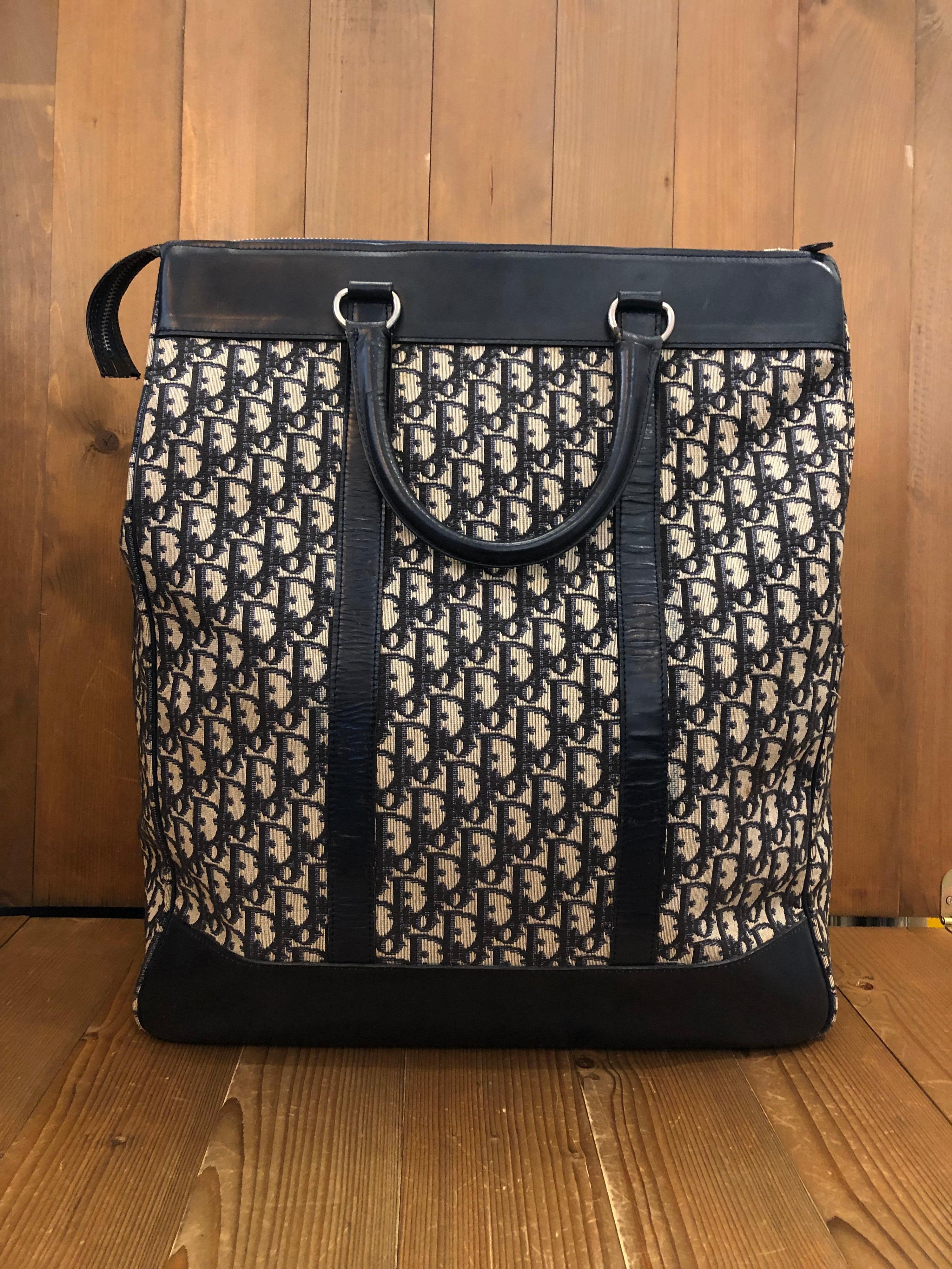 1970s CHRISTIAN DIOR boston bag in navy trotter jacquard with leather trimmings featuring one interior open pocket. Made in France. Measures 15.5 x 19.5 x 6 inches handle drop 5 inches

Condition: 
Outside: Minor aged marks on jacquard. Minor marks