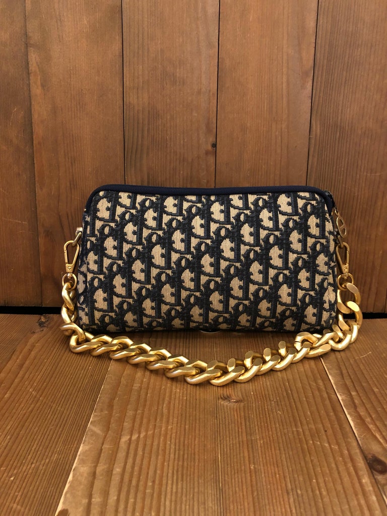 1970s CHRISTIAN DIOR Clutch bag in navy Trotter jacquard with leather interior. Medium in size which fits plus-sized cell phone and other small accessories. Made in France. Measures approximately 9.25 x 6 x 1.75 inches. Third party non-Dior parts