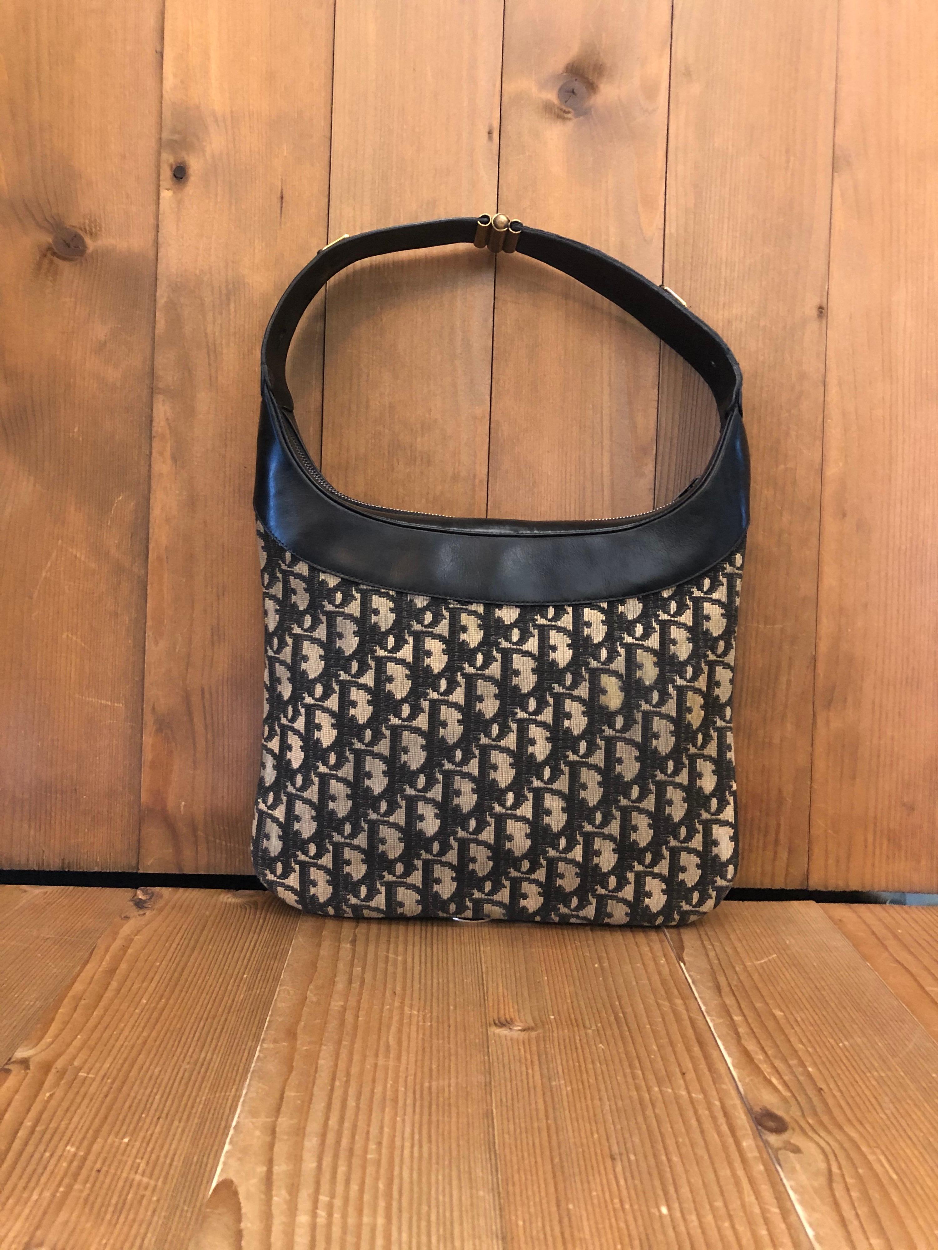 1970s Christian Dior pouch shoulder bag in navy trotter jacquard and leather. Made in France. Measures 10.5 x 8.5 inches
 
Condition - Some signs of wear consistent with age and normal use

Outside: Marks and stains throughout jacquard. Minor marks