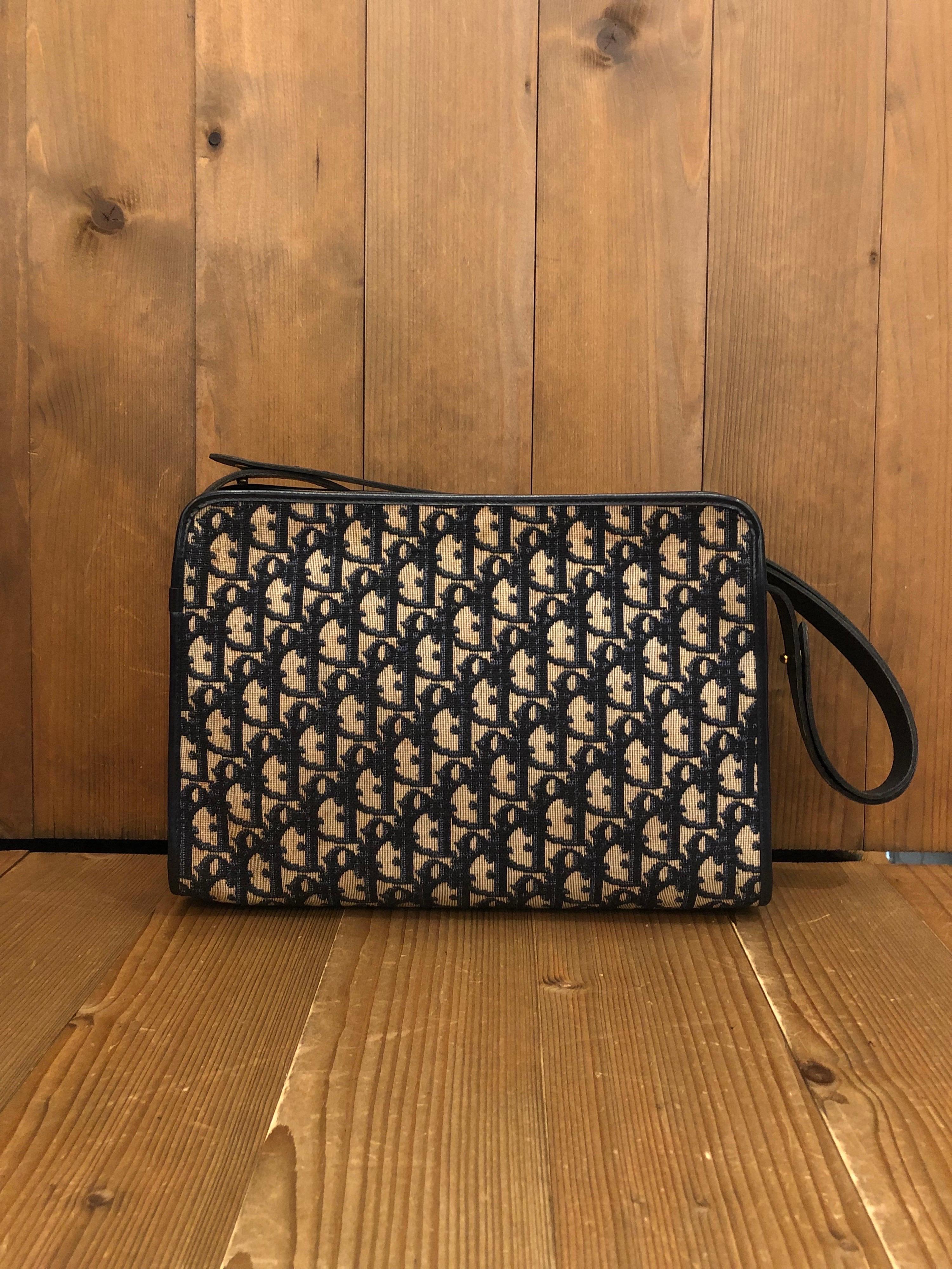 1970s Christian Dior shoulder bag in navy trotter jacquard and leather. Zipper top closure with one interior zip pocket. Made in France. Measures 11 x 8 x 3 inches Strap drop 9 inches extendable to 18 inches. Unisex style. It can be worn as a short
