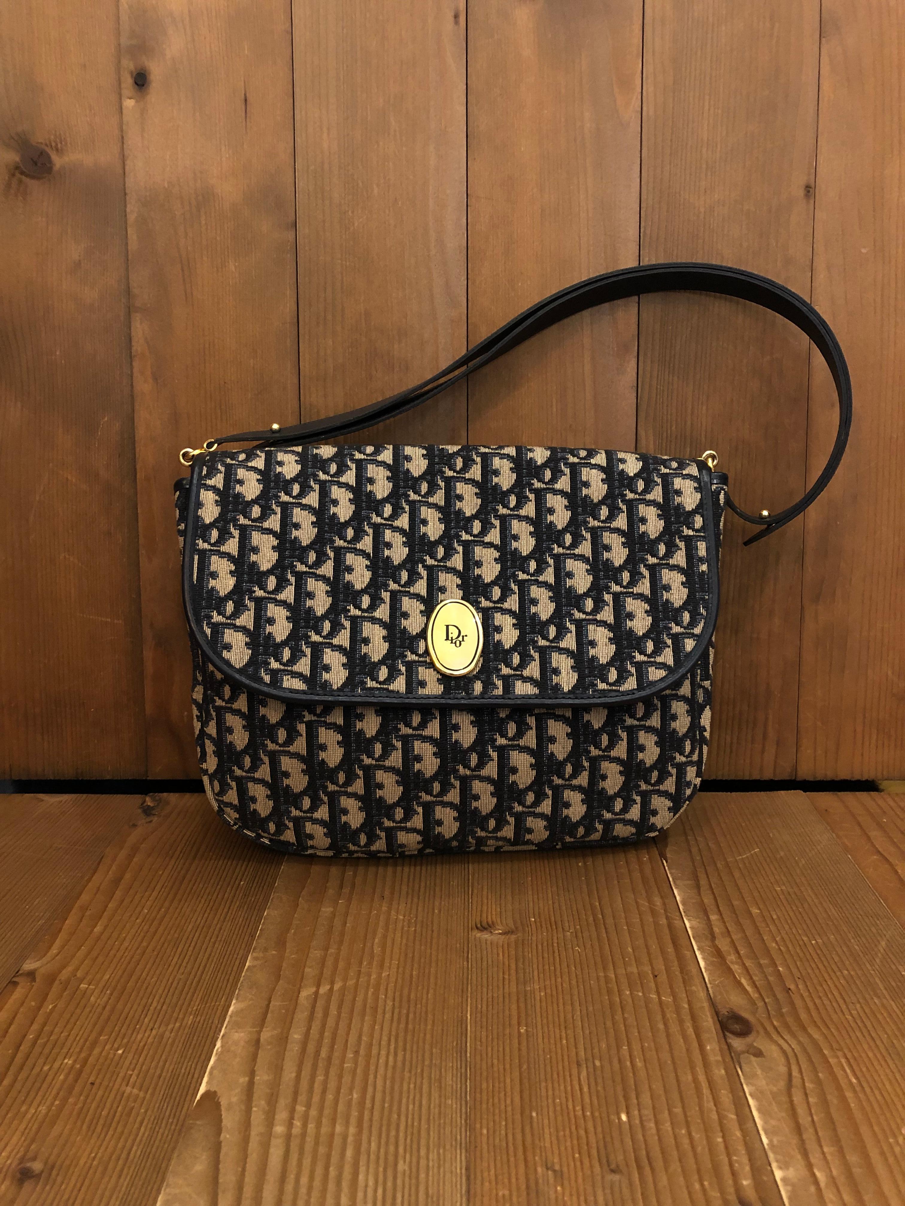 1970s Christian Dior shoulder bag in Dior's iconic navy trotter jacquard and leather. Made in France. Measures 10 x 8.5 x 2.5 inches Strap drop 9 inches extendable to 15 inches. Unisex style. It can be worn as a short crossbody bag. 

Condition -