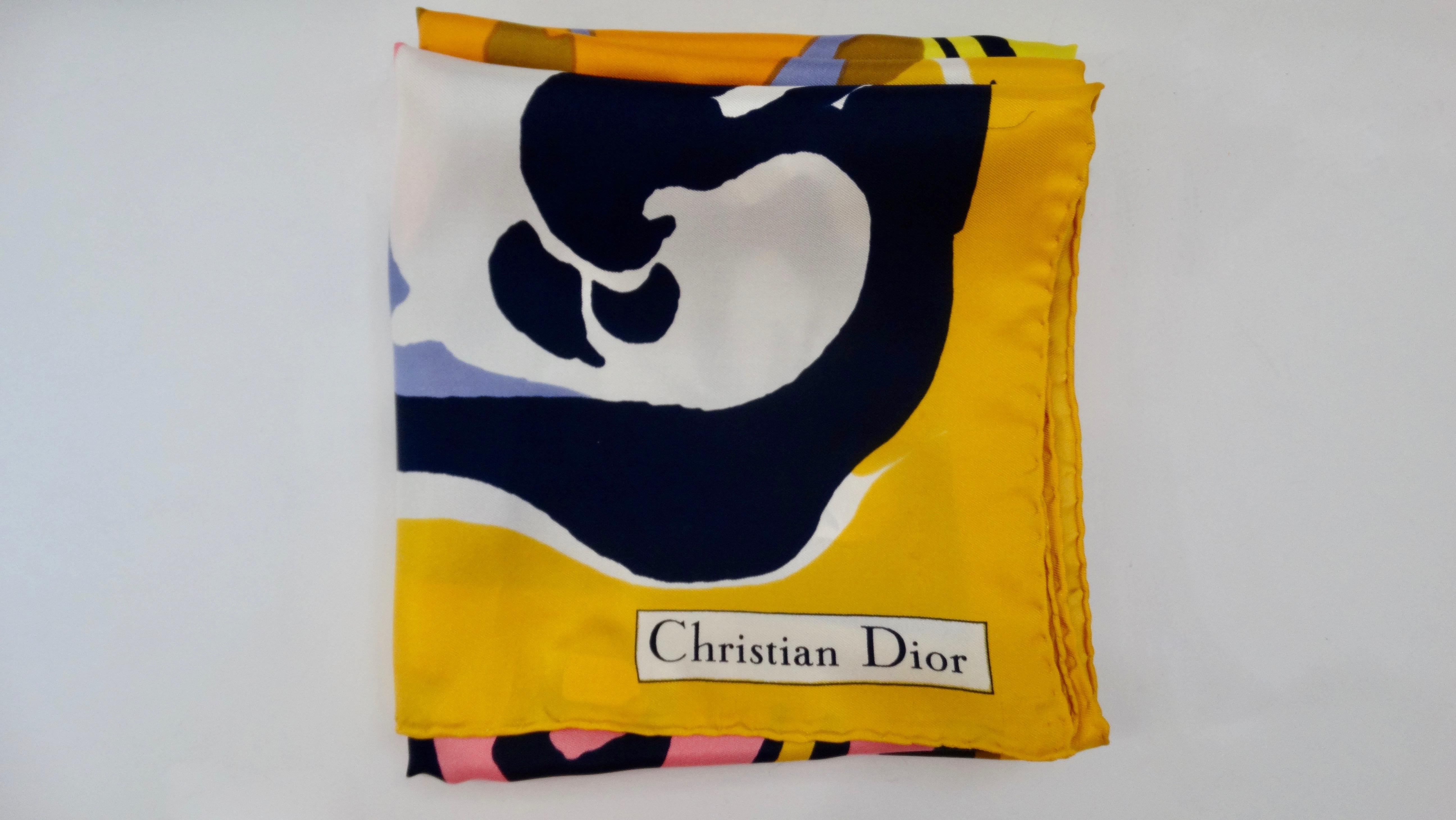 Add some vintage flare to your collection with this Christian Dior scarf! Circa 1970s, this 100% Silk scarf features a multi-colored motif of watercolor painted flowers, hearts, and swirls. Christian Dior in the bottom corner, rolled edges and a
