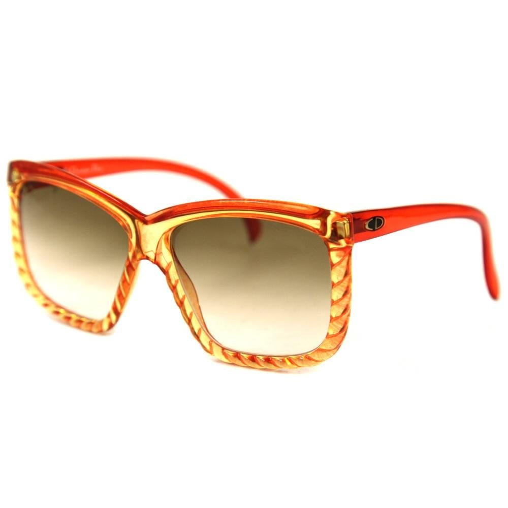 Glamorous Christian Dior sunglasses from the Seventies. The red frame is bold and sexy with some yellowy and orangy intertwined details. Temples have a very vivid red colour. Good conditions.
Please note this item cannot be shipped to the