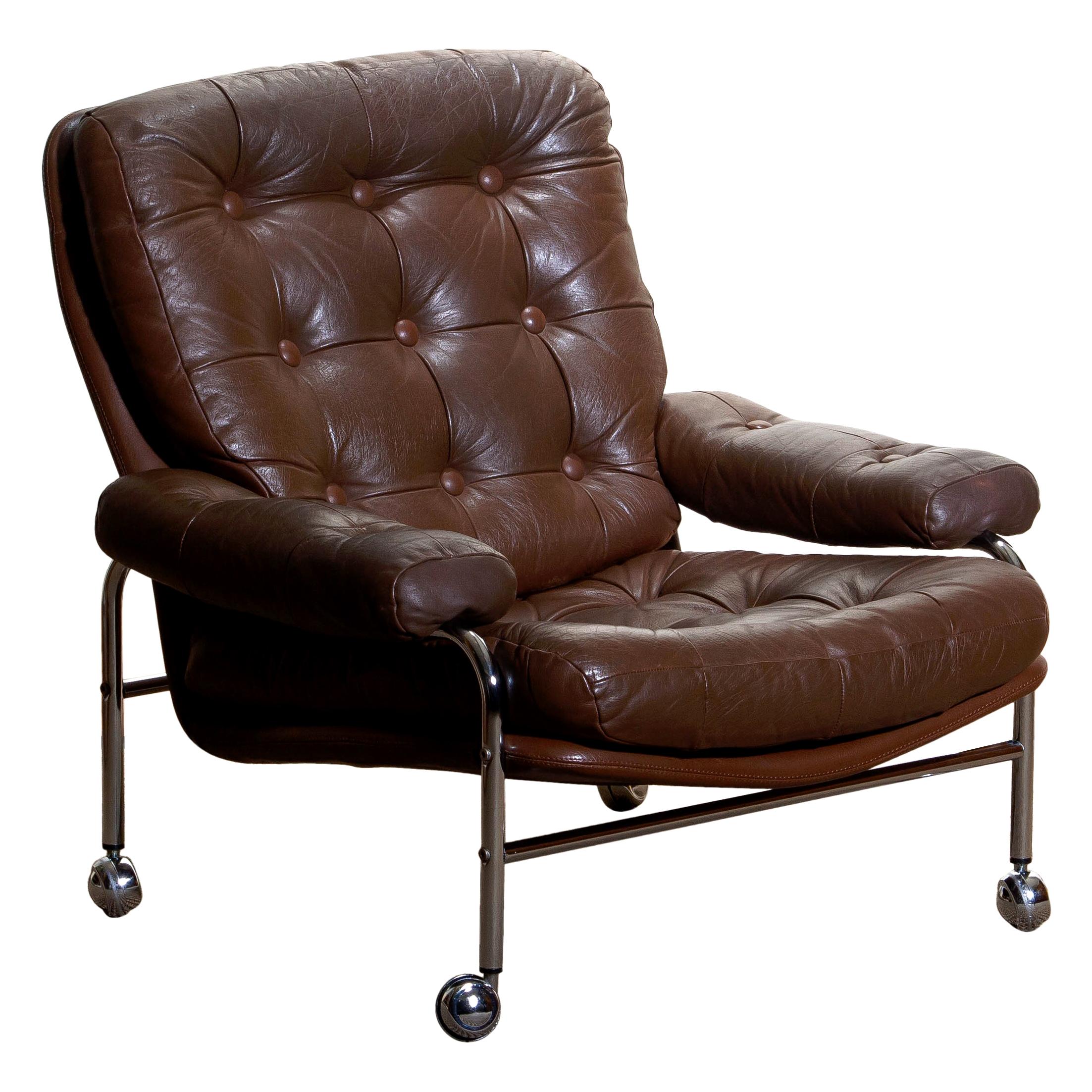 Extremely comfortable easy or lounge chair made by Scapa Rydaholm, Sweden.
This, typical Scandinavian chair is upholstered with brown leather based on a chromed metal frame.
All in perfect condition.
Note: We have two chairs on stock!
 