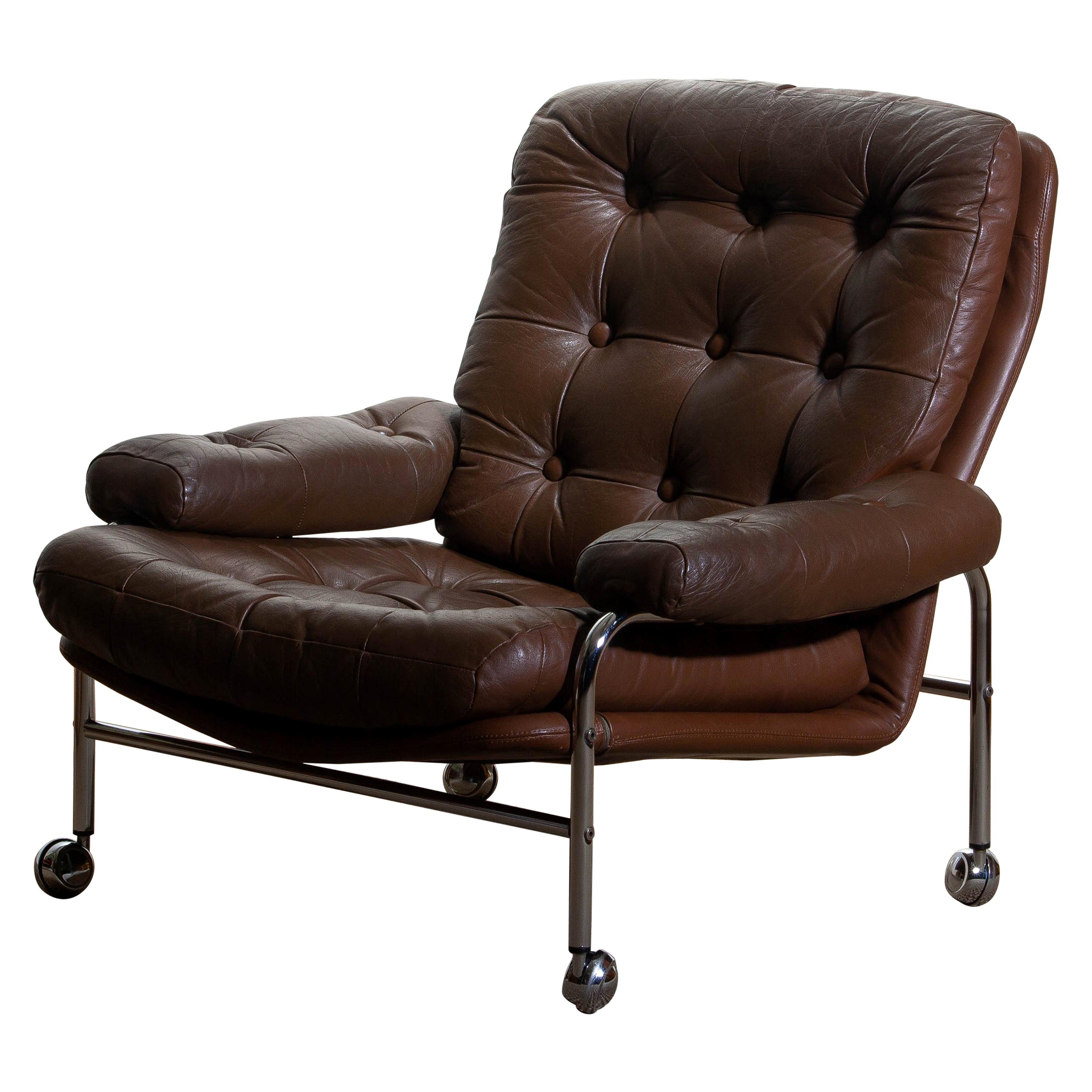 Extremely comfortable easy or lounge chair made by Scapa Rydaholm, Sweden.
This, typical Scandinavian chair is upholstered with brown leather based on a chromed metal frame.
All in perfect condition.

 