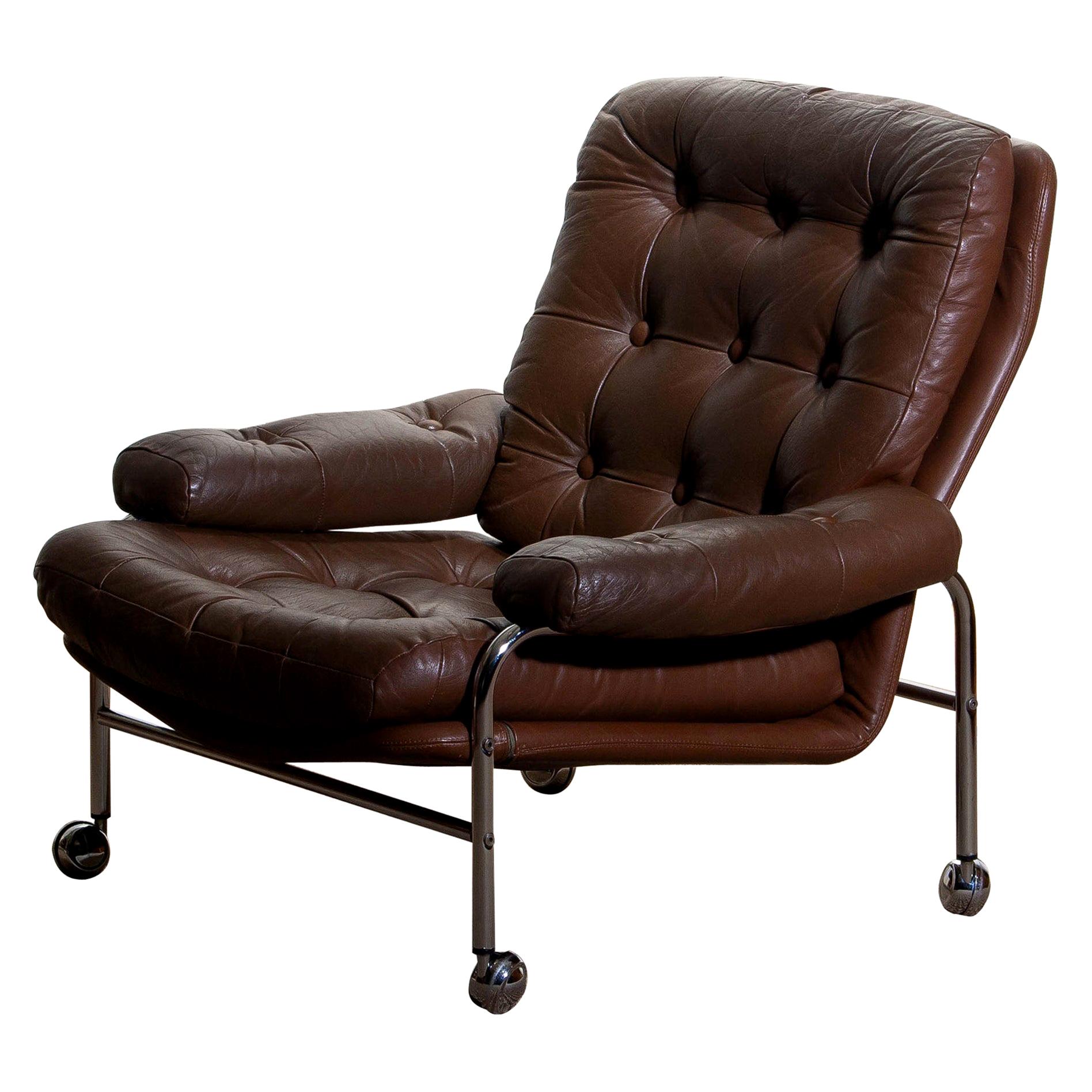 Extremely comfortable easy or lounge chair made by Scapa Rydaholm, Sweden.
This, typical Scandinavian chair is upholstered with brown leather based on a chromed metal frame.
All in perfect condition.

   