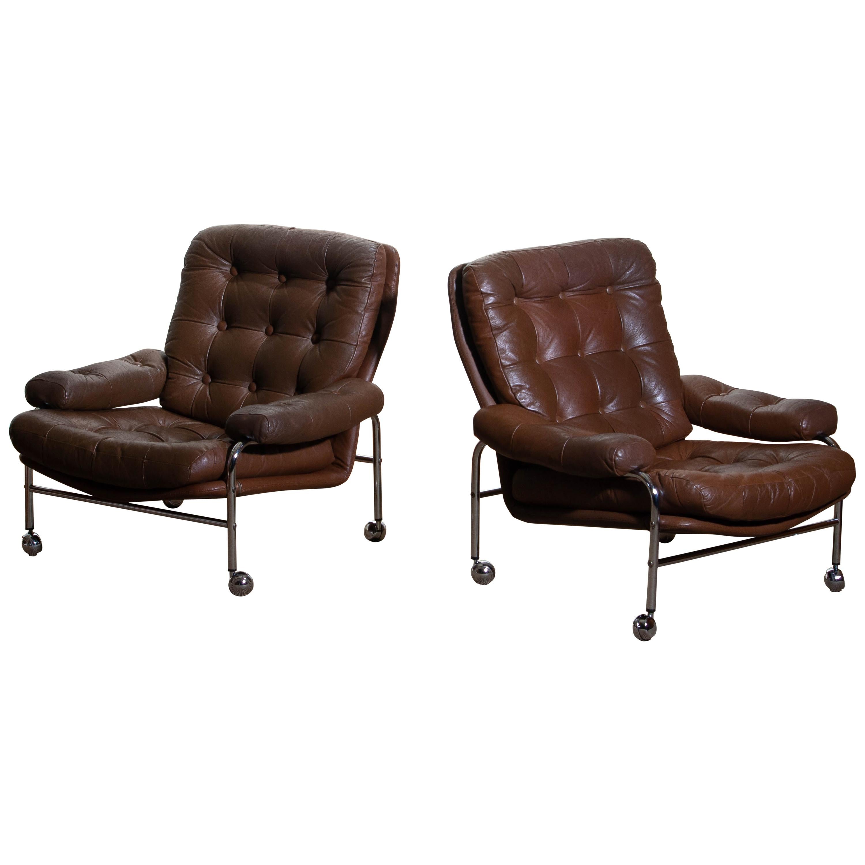 Beautiful set of two extremely comfortable easy or lounge chairs made by Scapa Rydaholm, Sweden.
These, typical Scandinavian chairs are upholstered with brown leather-based on a chromed metal frame.
All in perfect condition.

Period: 1970.
   