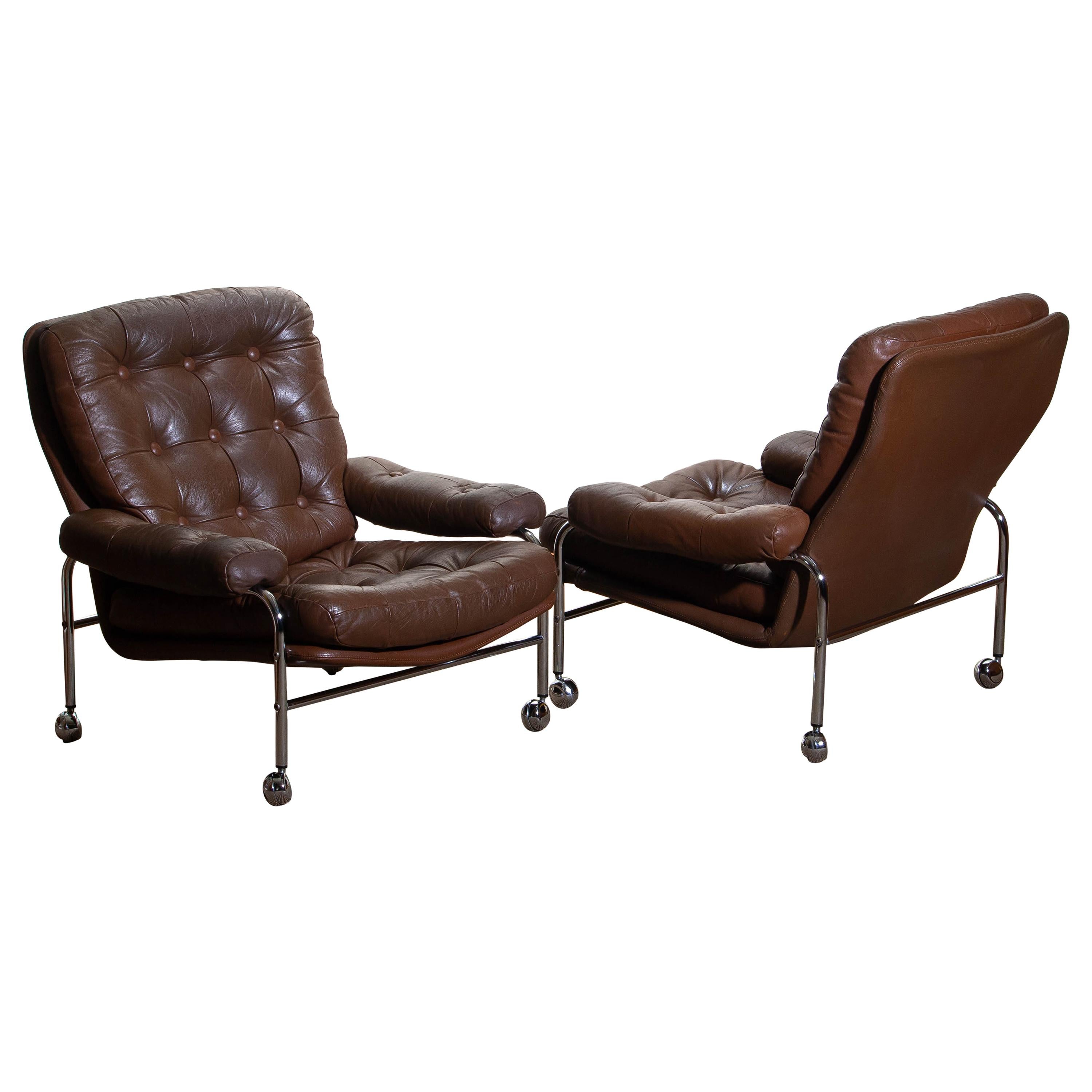 Beautiful set of two extremely comfortable easy or lounge chairs made by Scapa Rydaholm, Sweden.
These, typical Scandinavian chairs are upholstered with brown leather-based on a chromed metal frame.
All in perfect condition.

Period: 1970.
 