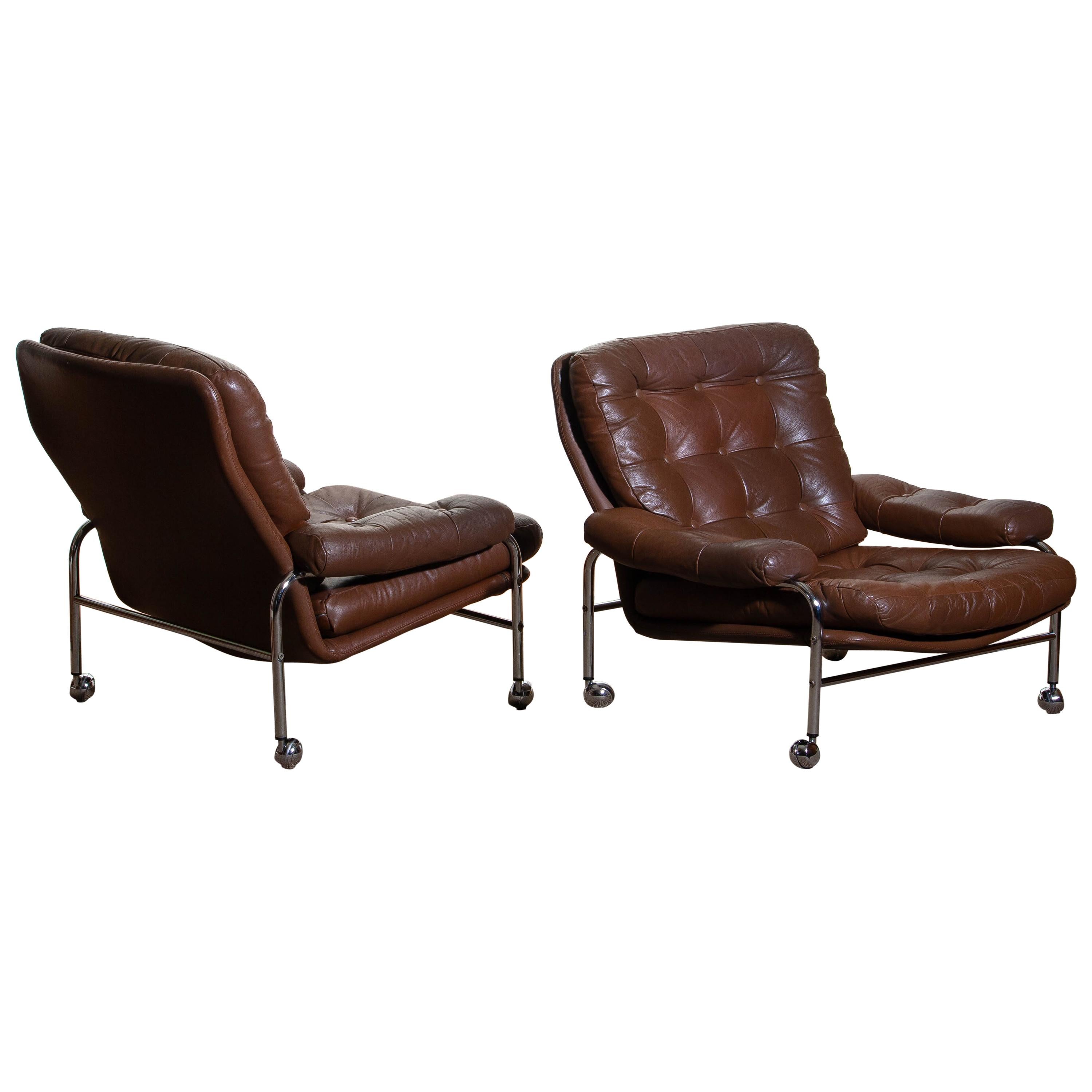 Beautiful set of two extremely comfortable easy or lounge chairs made by Scapa Rydaholm, Sweden.
These, typical Scandinavian chairs are upholstered with brown leather-based on a chromed metal frame.
All in perfect condition.

Period: 1970.
   