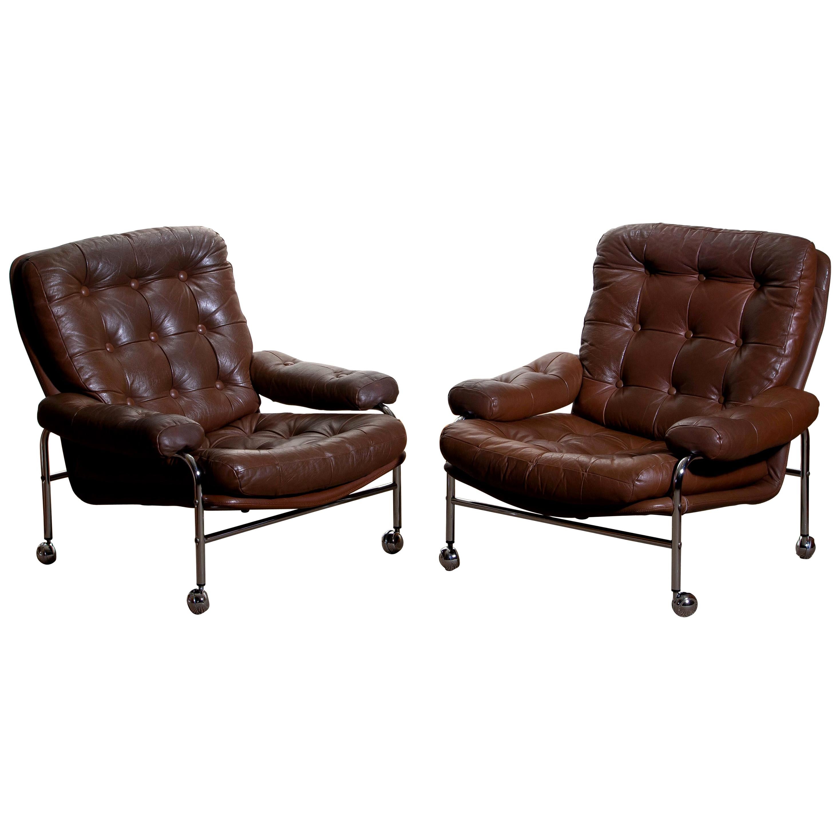Beautiful set of two extremely comfortable easy or lounge chairs made by Scapa Rydaholm, Sweden.
These, typical Scandinavian chairs are upholstered with brown leather-based on a chromed metal frame.
All in perfect condition.

Period: 1970.
  