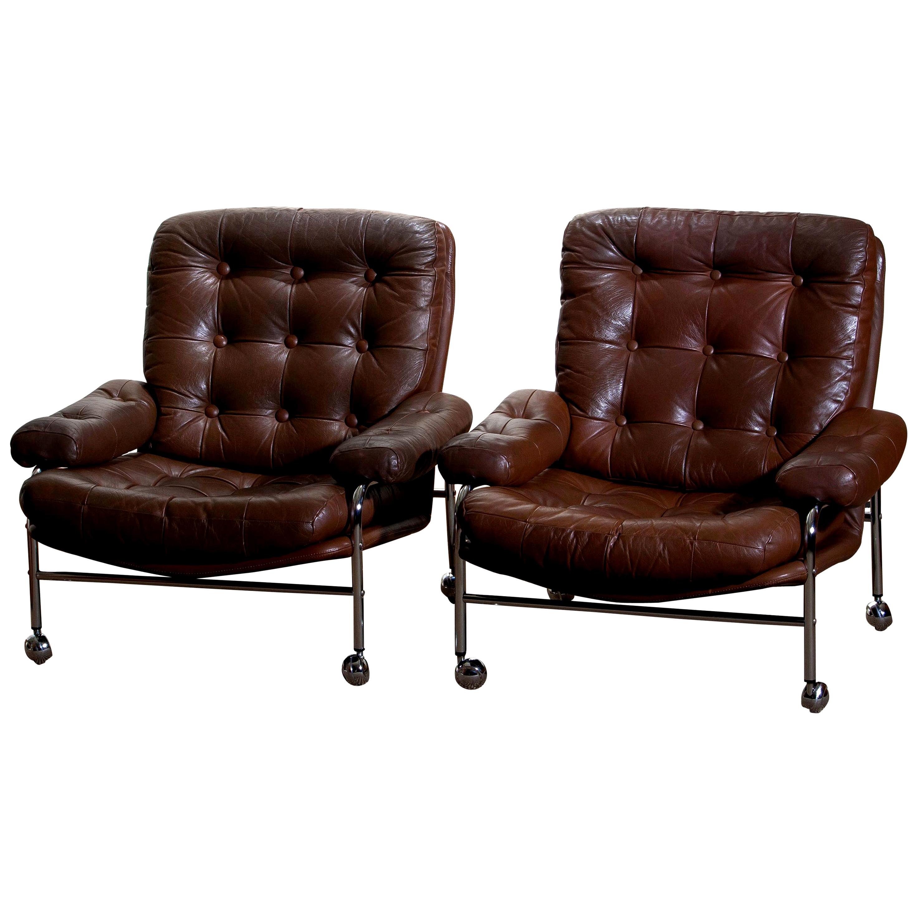 Beautiful set of two extremely comfortable easy or lounge chairs made by Scapa Rydaholm, Sweden.
These, typical Scandinavian chairs are upholstered with brown leather-based on a chromed metal frame.
All in perfect condition.

Period: 1970.
 