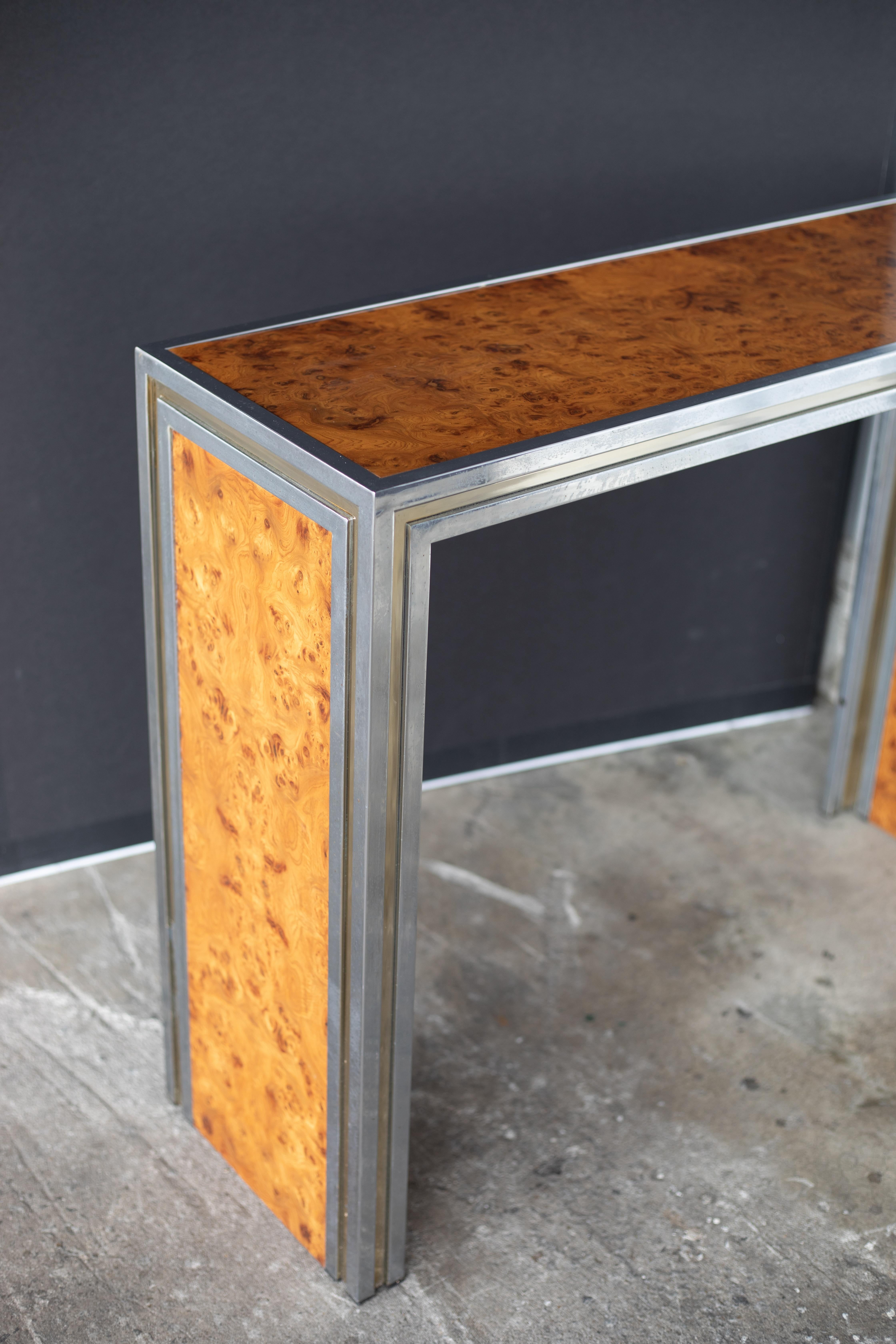 Elegant Mid-Century Modern chrome and maple console table, circa 1970s. The sleek rectangular form features a polished chrome frame that encases a warm maple wood top and side insets, creating a balanced contrast between reflective metal and natural