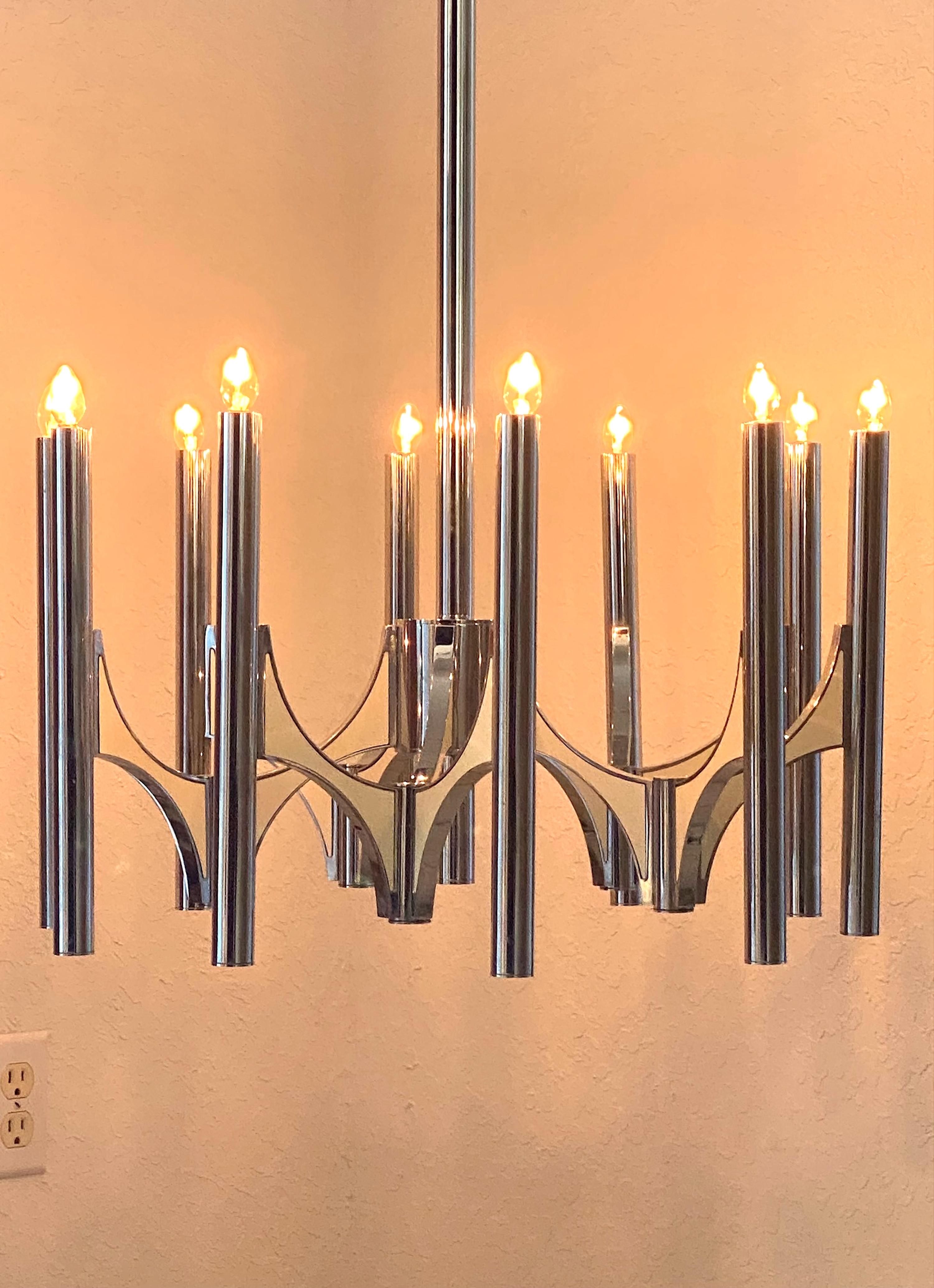 Interesting Gaetano Sciolari 10 ligths Chandelier, each tube holds a  candelabra light bulb and metal panels on the arms. 
The enameled metal panels hold each other with magnets.
The original Sciolari sticker still in place.
Please note, we have a