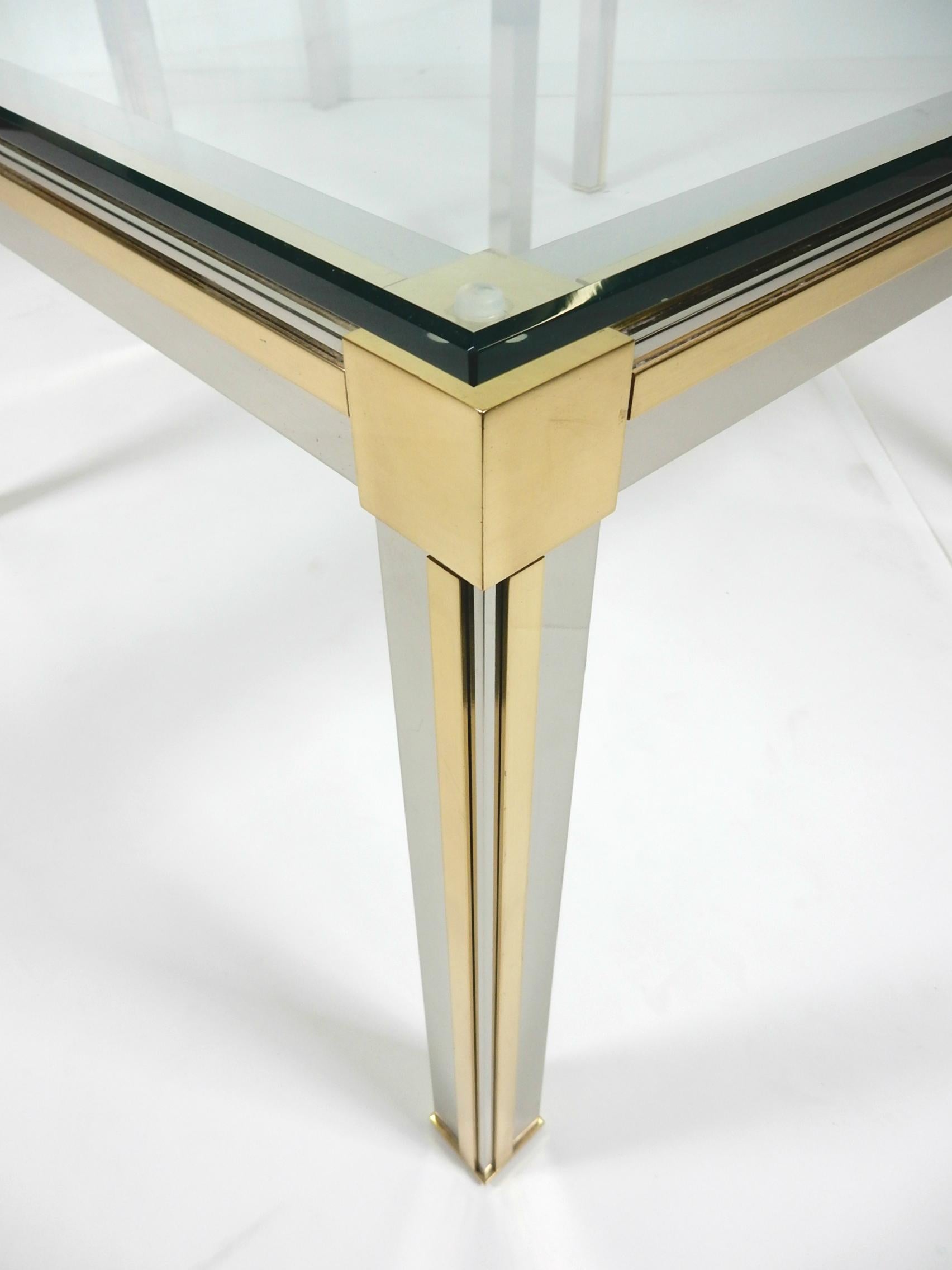 Exceptional pair of large chrome and brass side tables attributed to designer Romeo Rega.
Heavy, well crafted quality tables with thick glass tops.
Clean, sharp edge design. Could be used together as a large cocktail table.