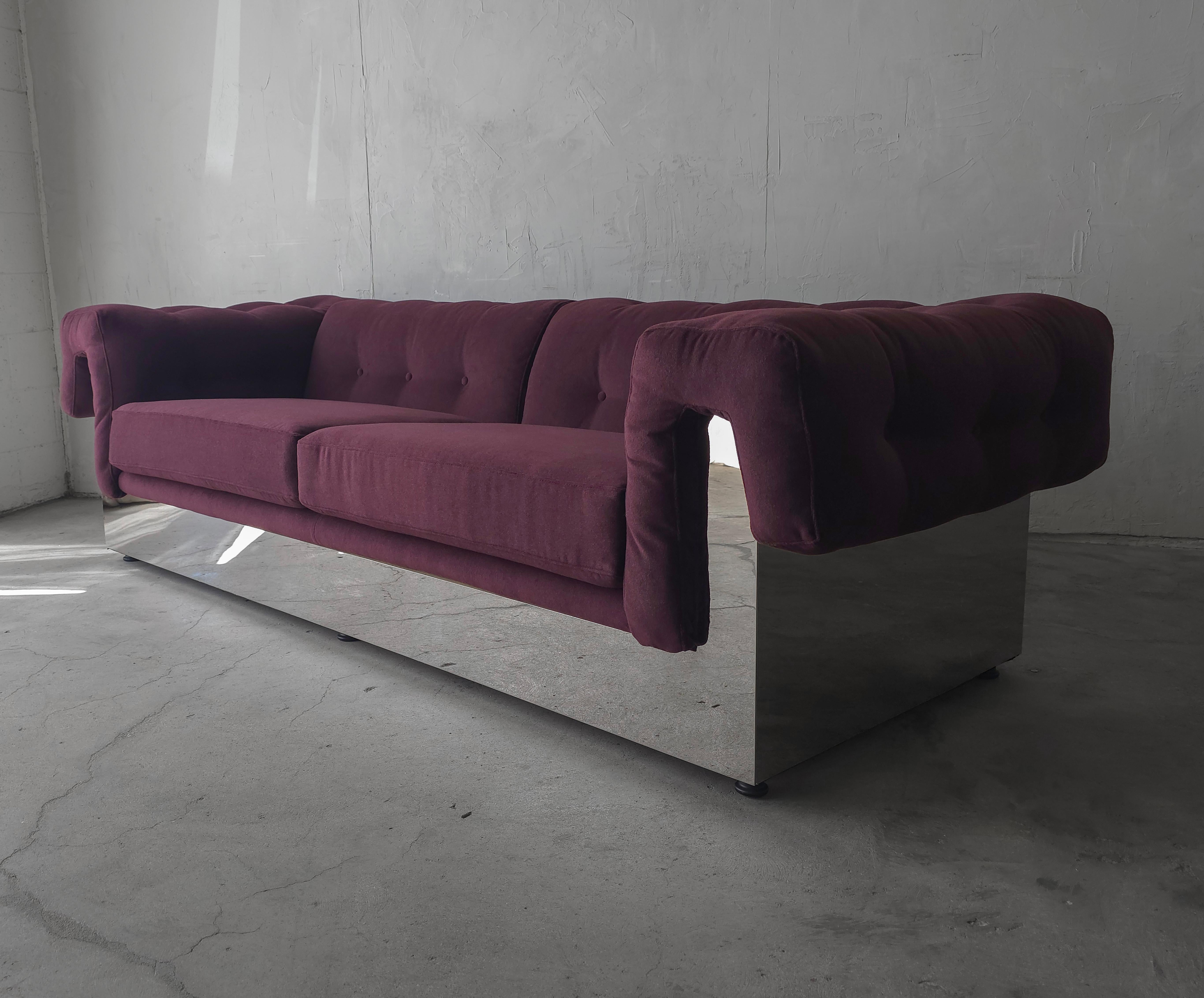 Dressed in beautiful deep plum mohair, this incredible steel clad sofa by Milo Baughman for Thayer Coggin is a true classic.  The tufting and mirrored chrome finish make this piece a true show stopping centerpiece.

This style comes in several