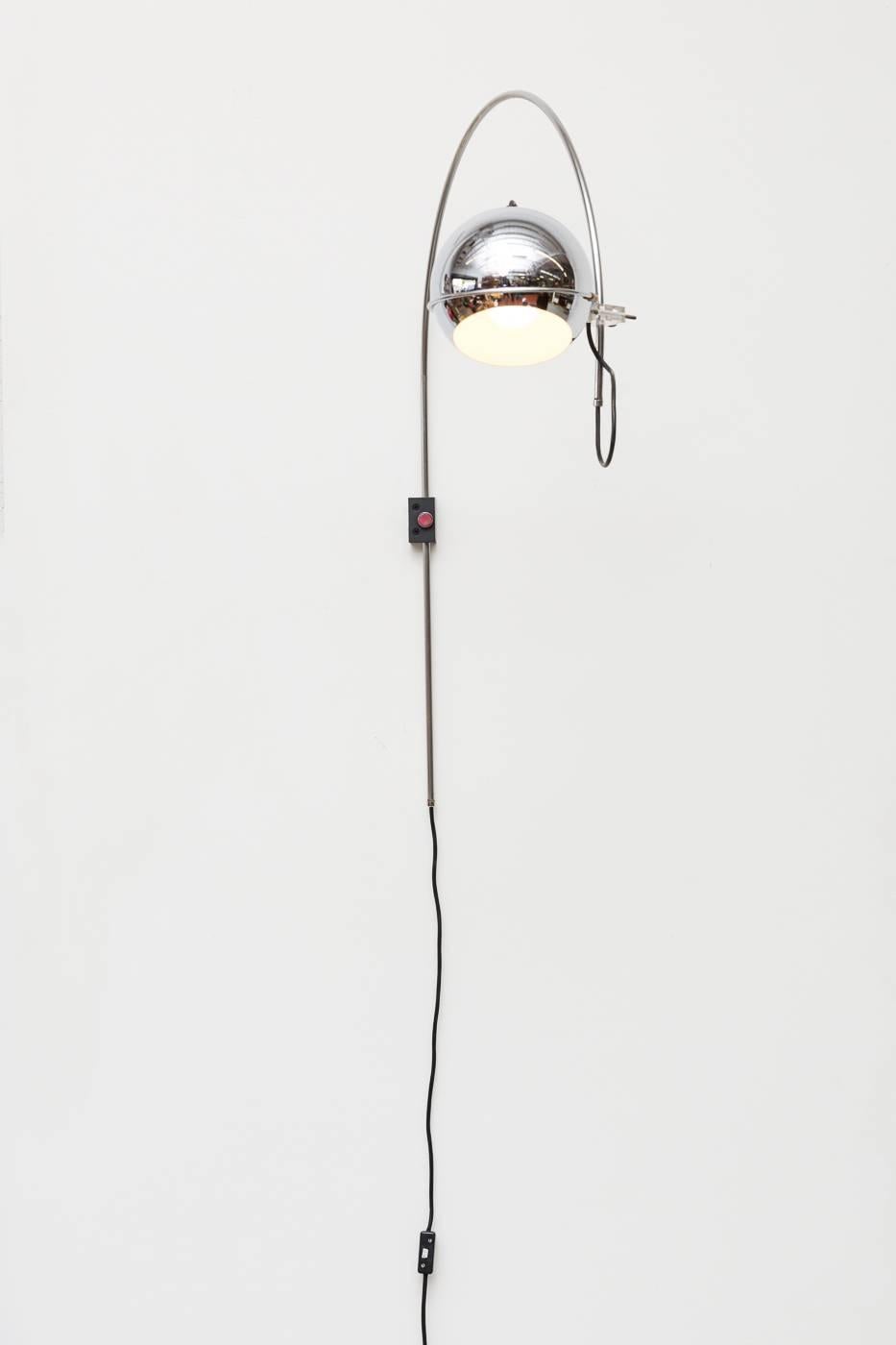 1970s midcentury chrome Gepo arc wall lamp with acrylic hardware and black rectangular mount. Good original condition with visible wear consistent with its age and usage.