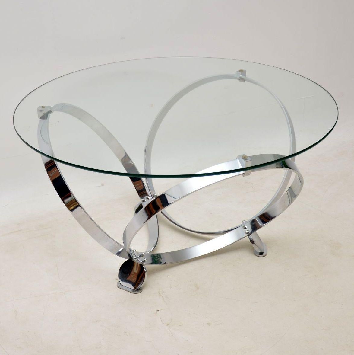 An exceptionally stylish and extremely well made coffee table in chromed steel and glass, this was designed by Knut Hesterberg, it was made in Germany in the 1970s. It has a striking design with three large chrome rings, linked at the base by three