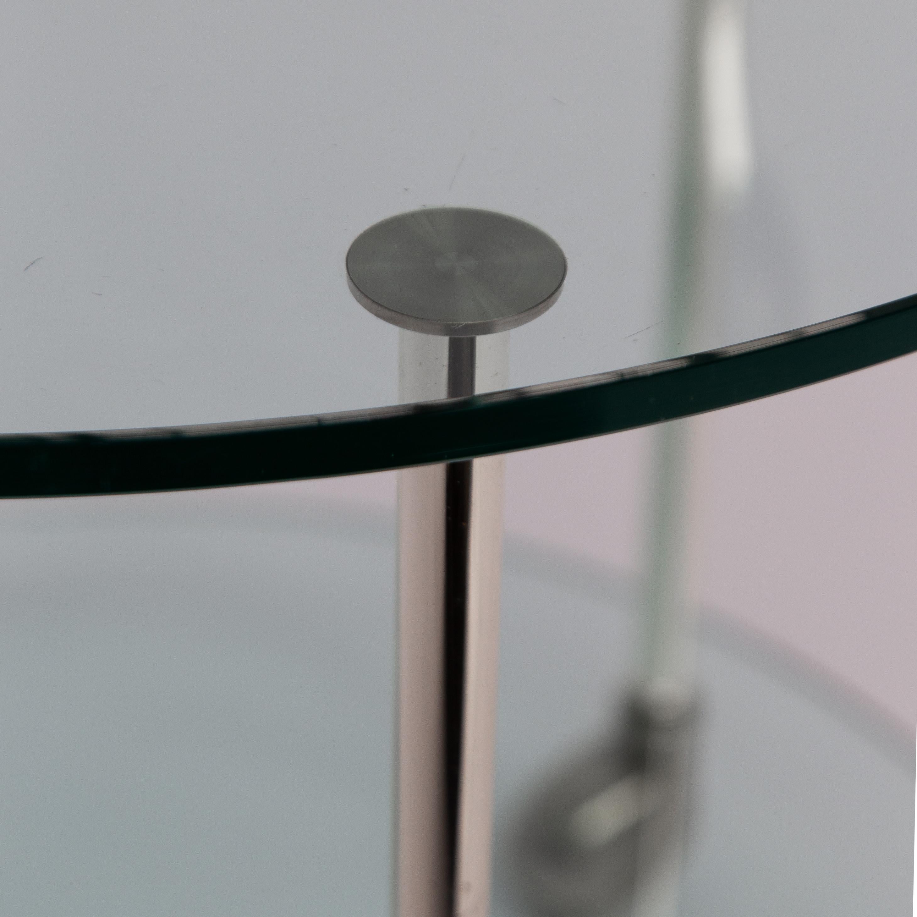 The 1970s Chrome Round Cocktail Bar Cart is a great example of mid-century design, still popular for its elegant look. The piece features a chrome finish and glass shelves, making it both practical and stylish. The round shape and minimalist design