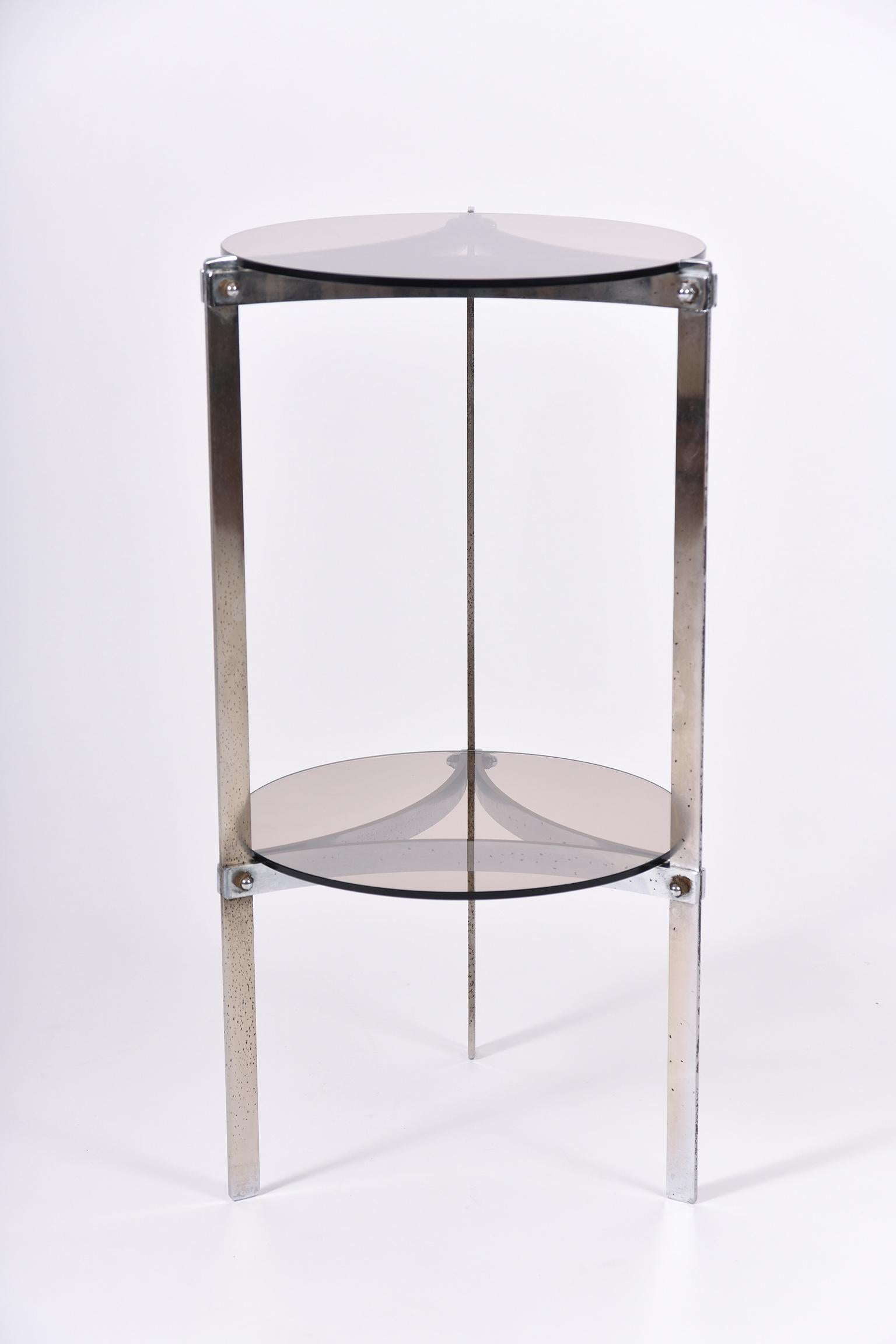 A smoked glass and chrome two-tier side table
France, circa 1970.