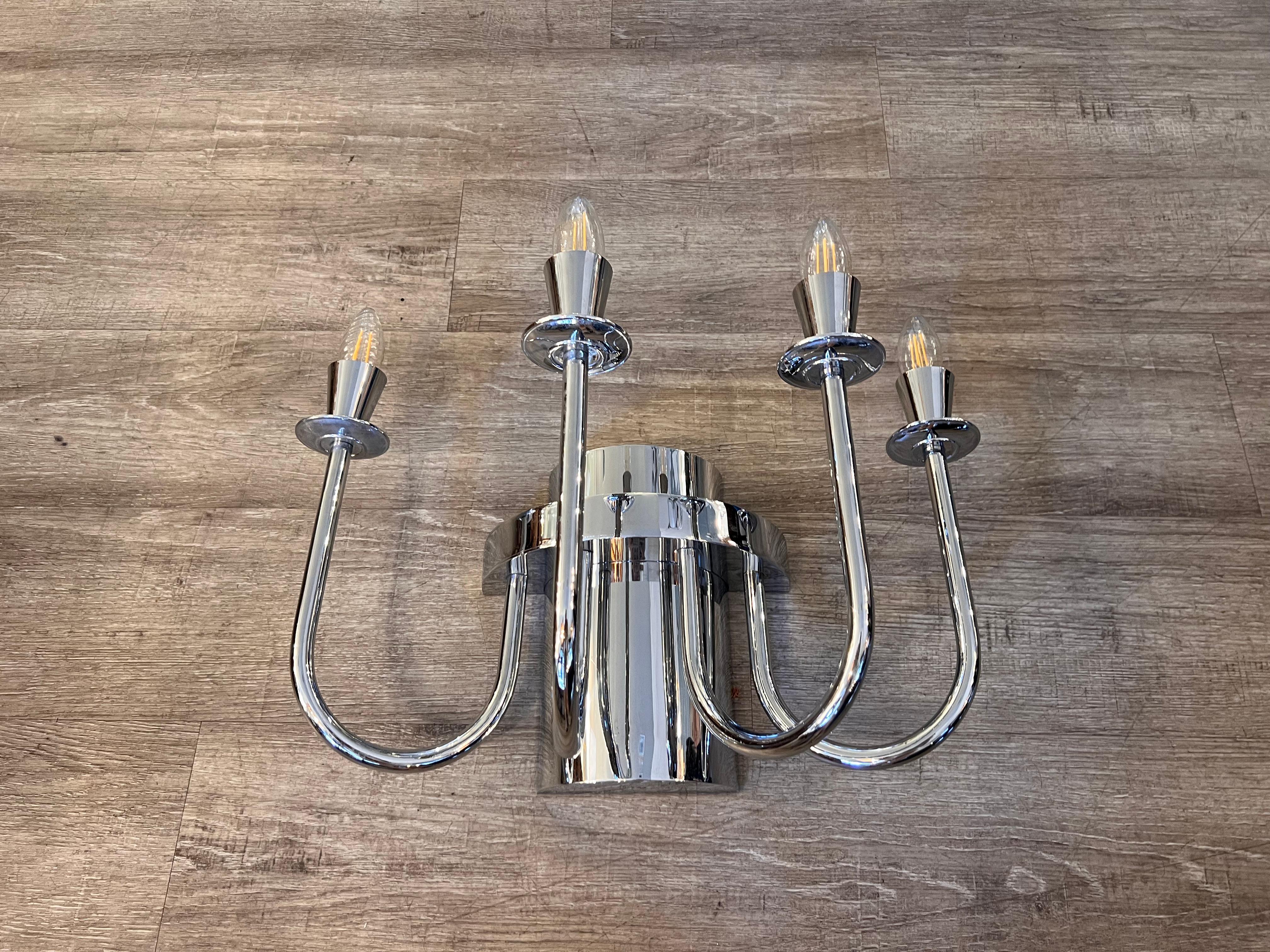 A pair of chrome steel wall sconces from the 1970s. Each piece carries 4 lights. 
Price refers to the couple.